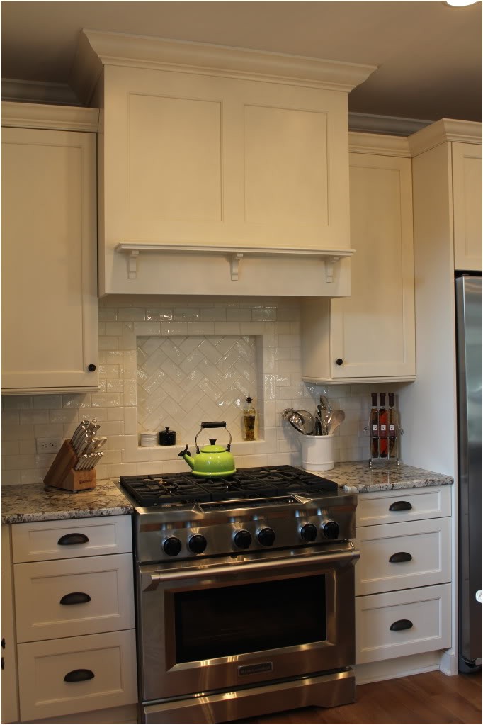 almost finished light and dark kitchen with white alaska granite