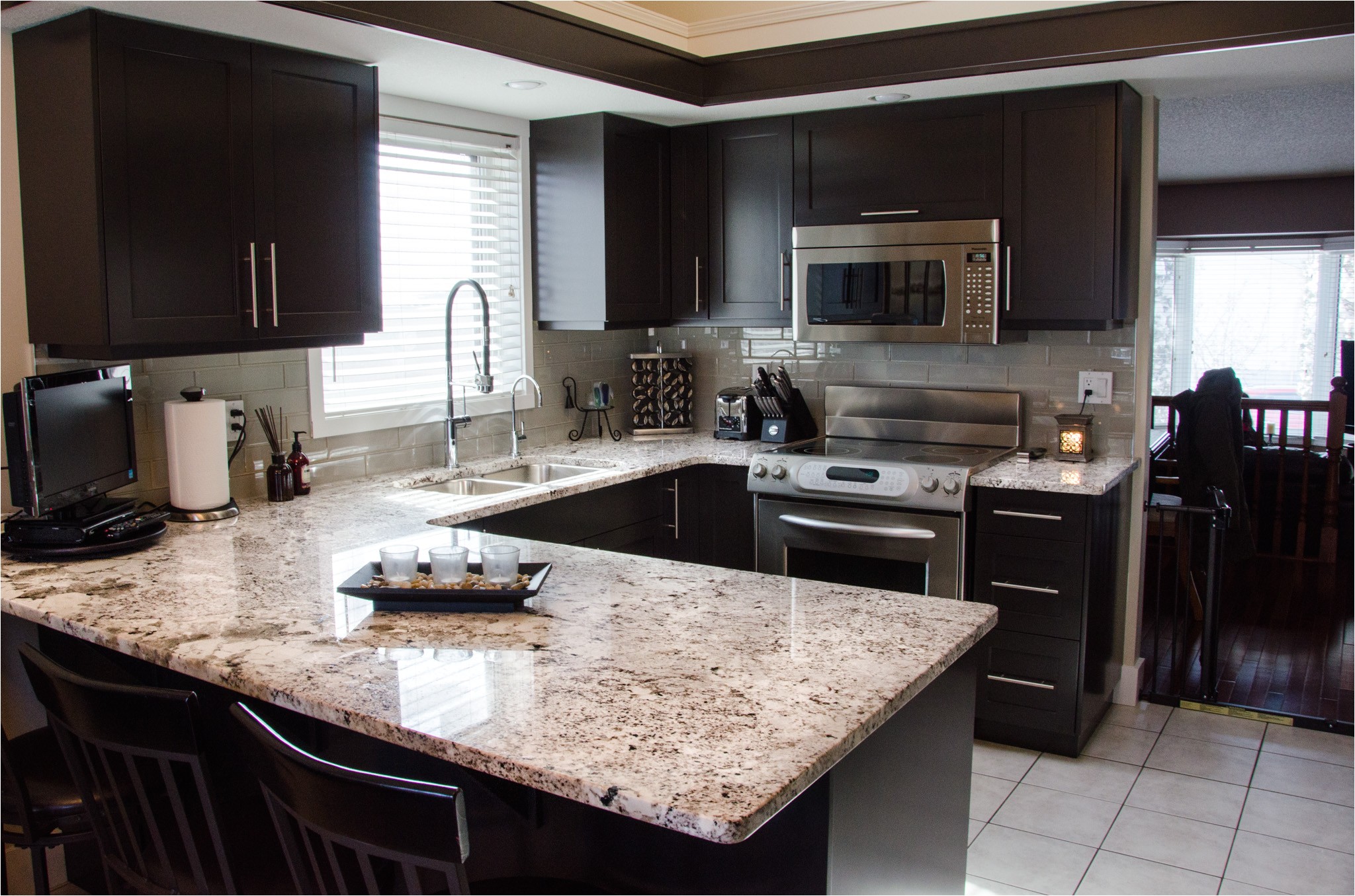 modern minimalist kitchen with espresso cabinet and alaskan white granite countertop plus stainless steel sink