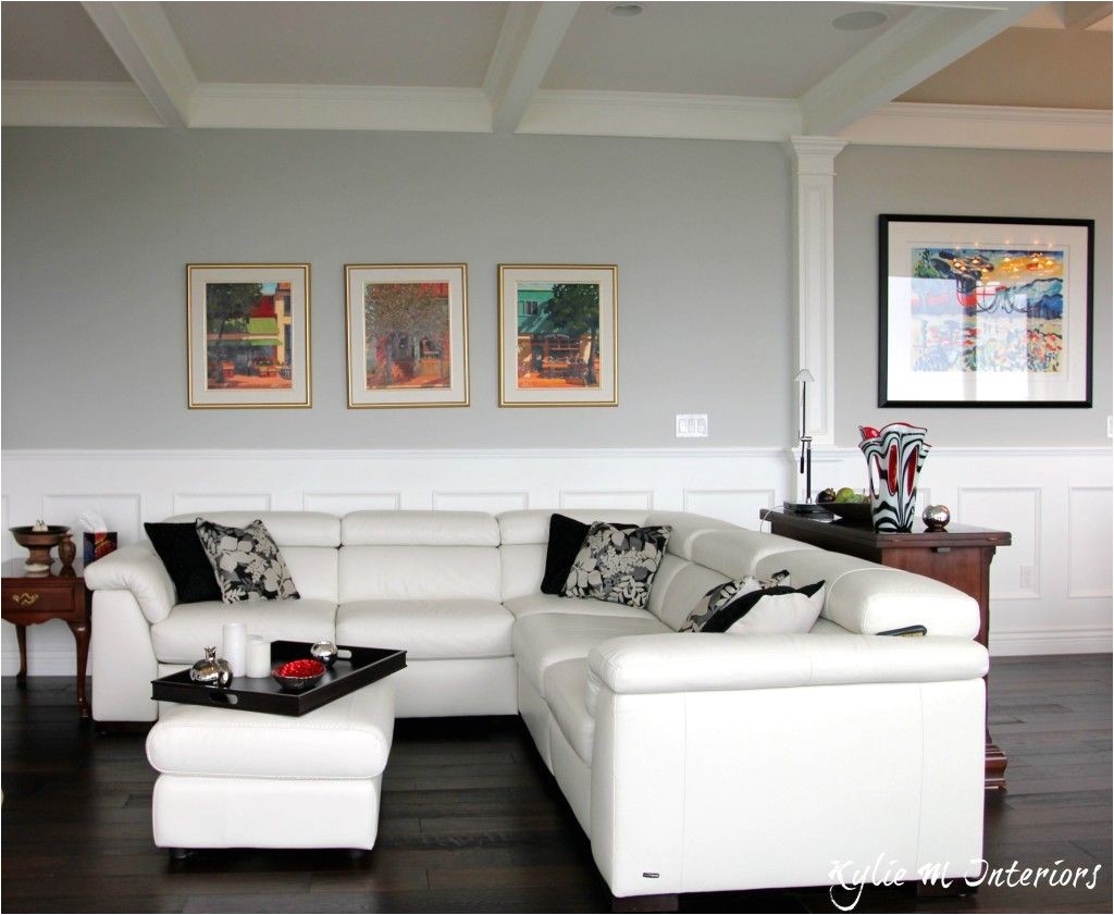 best benjamin moore gray paint color stonington gray shown with white leather sectional dark wood floors and wainscoting