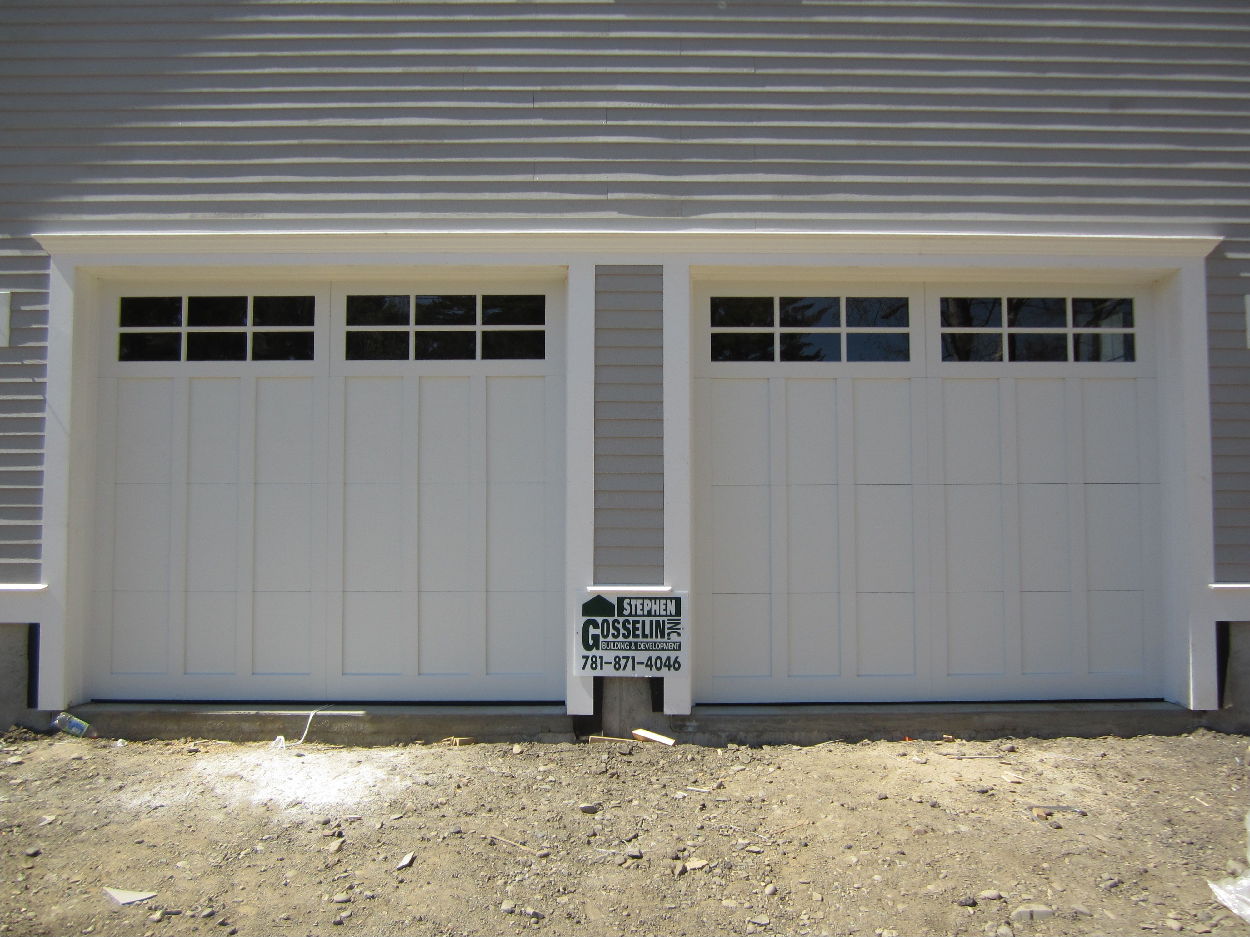 haas american tradition model 922 steel carriage house style garage doors in white with 6 pane glass installed by mortland overhead door mortlanddoor com