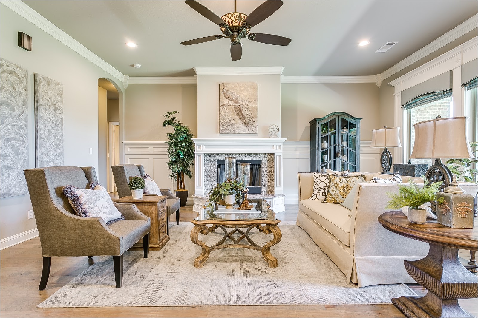 rustic hardwood floors are nicely paired with contemporary light fixtures and tile back splash the custom wood cabinets to the ceiling with glass cupboards