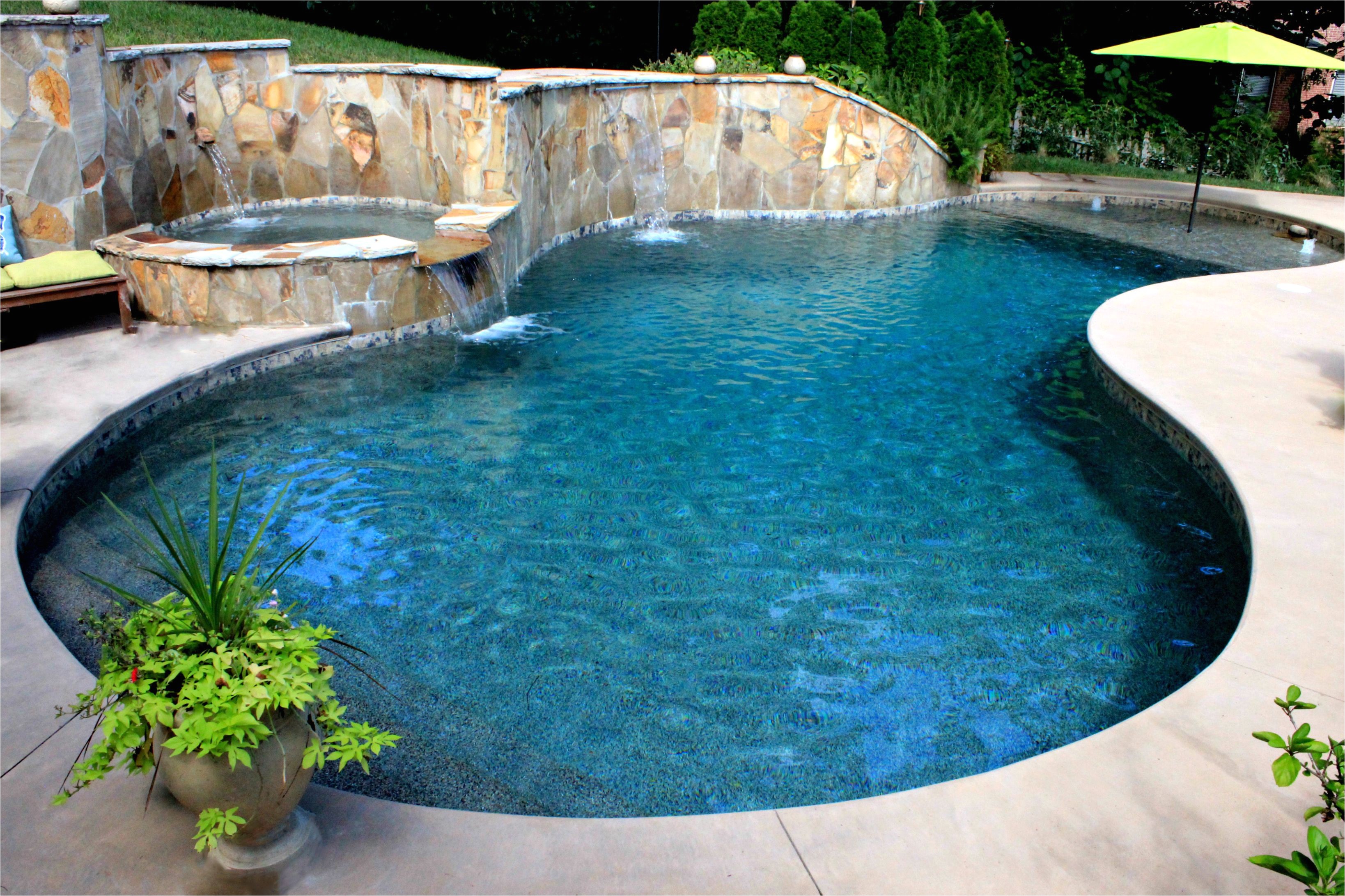 custom gunite pool with beach entry tanning ledge spa and scuppers