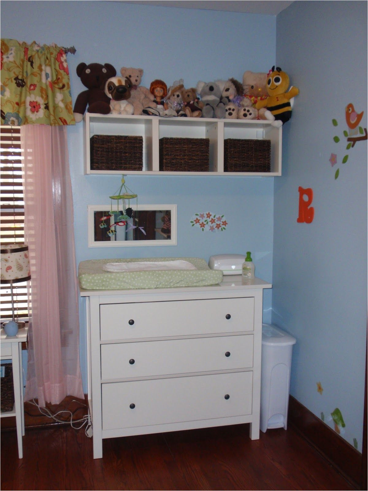 storage above changing table like the use of baskets to organize