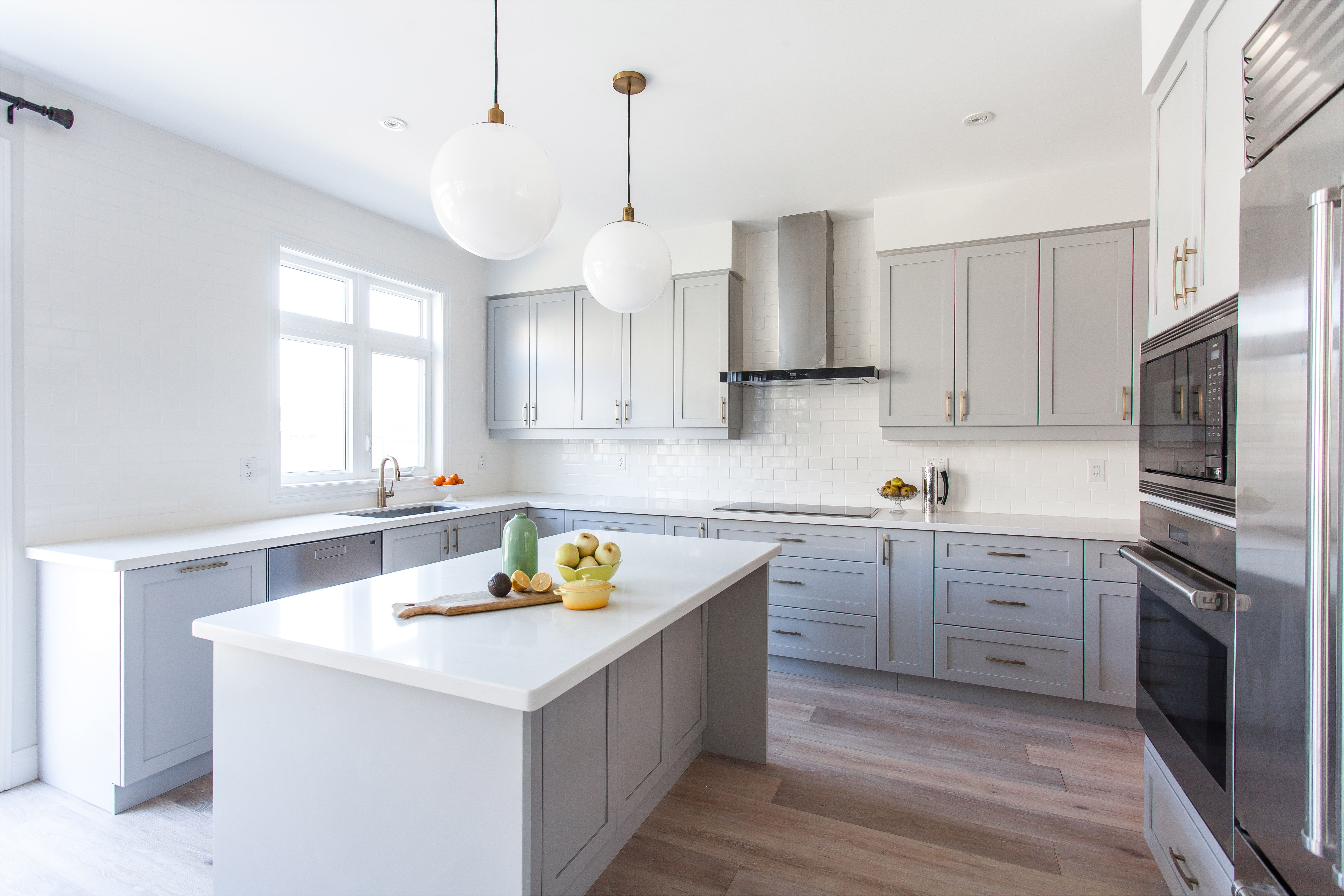 storage contemporary light grey wooden light colored kitchen cabinets oak hardwood flooring white granite countertop built in oven light grey wooden kitchen