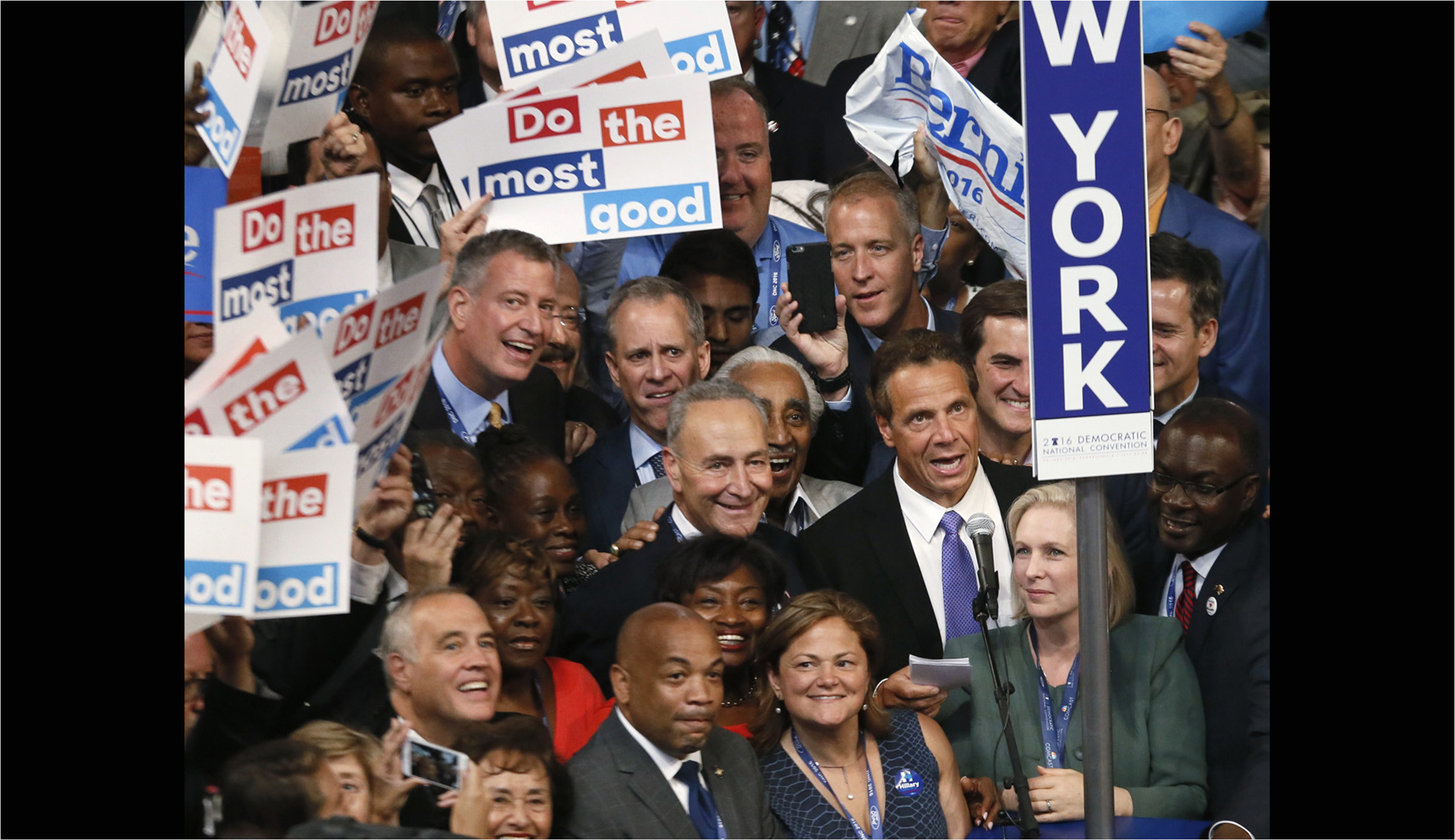 delegates from the state of new york stand with signs