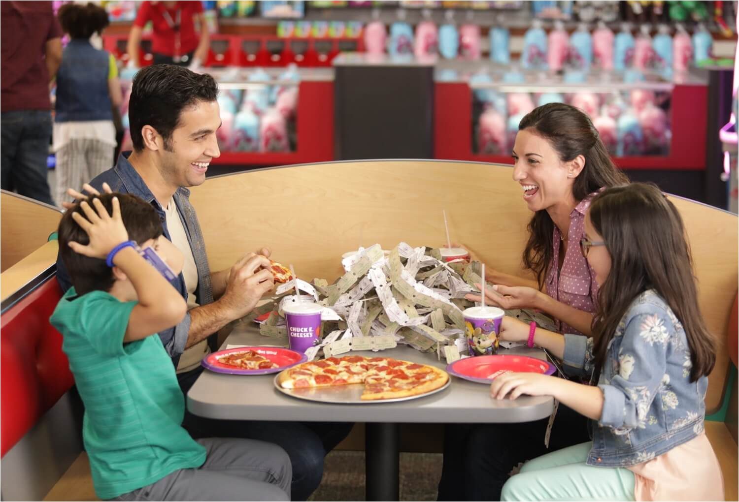 family eating pizza with tickets on the table