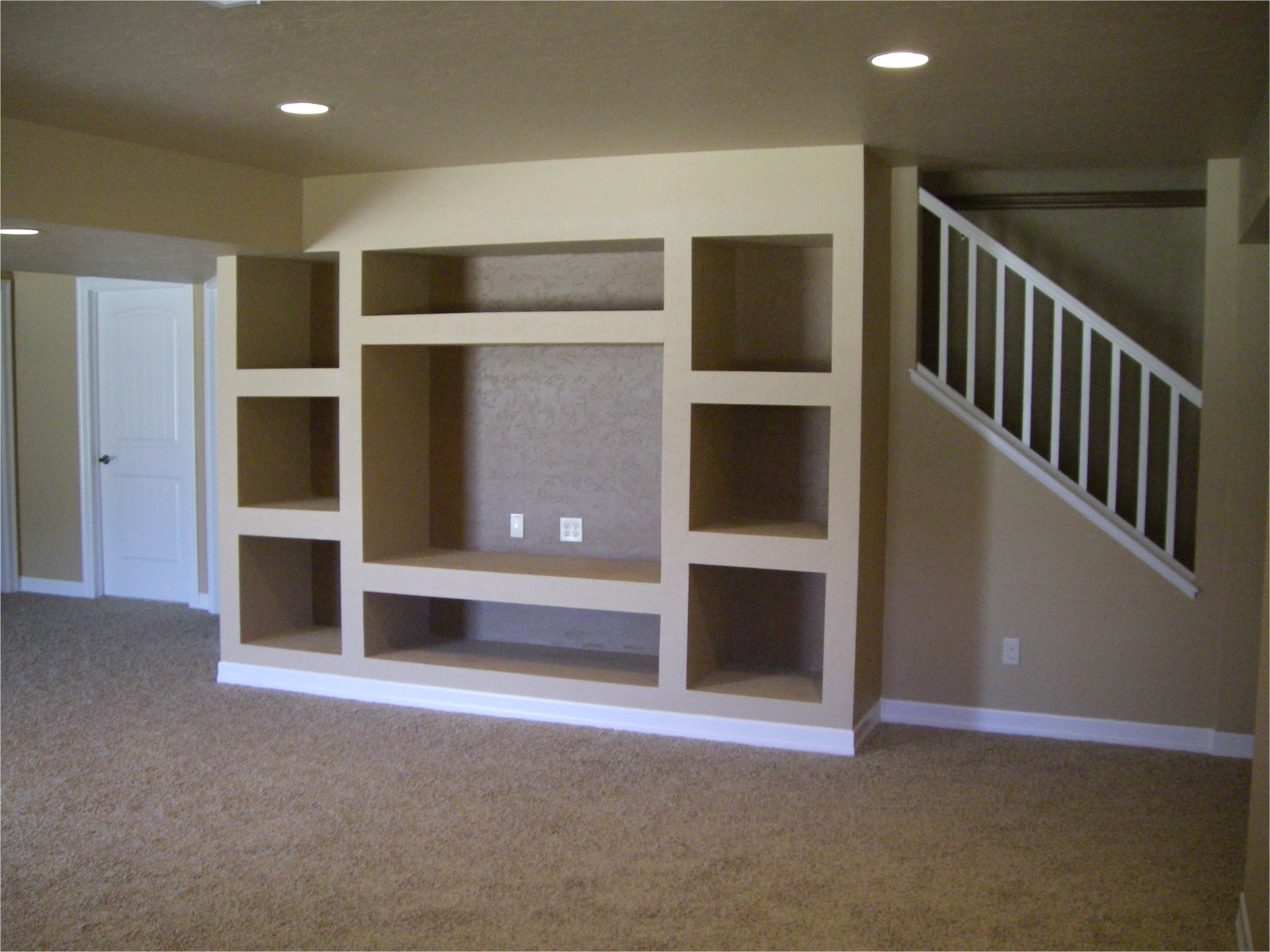 open stairs with support beam built in entertainment center only issue i see is that you would really have to like that spot for your tv and such to go