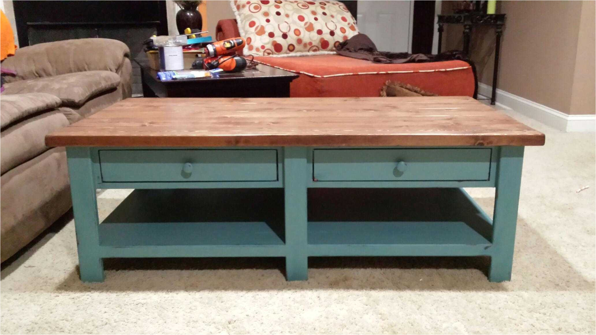 a coffee table with two drawers and a lower bench