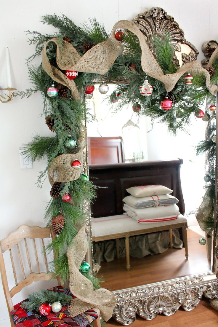 burlap greens and vintage ornament garland on mirror from rusty hinge