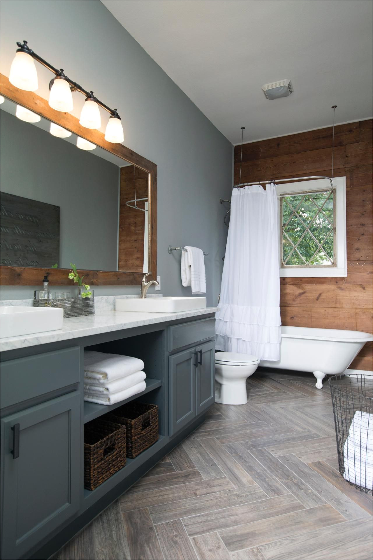 chip and joanna gaines decked out this master bathroom with new gray paint and a shiplap accent wall