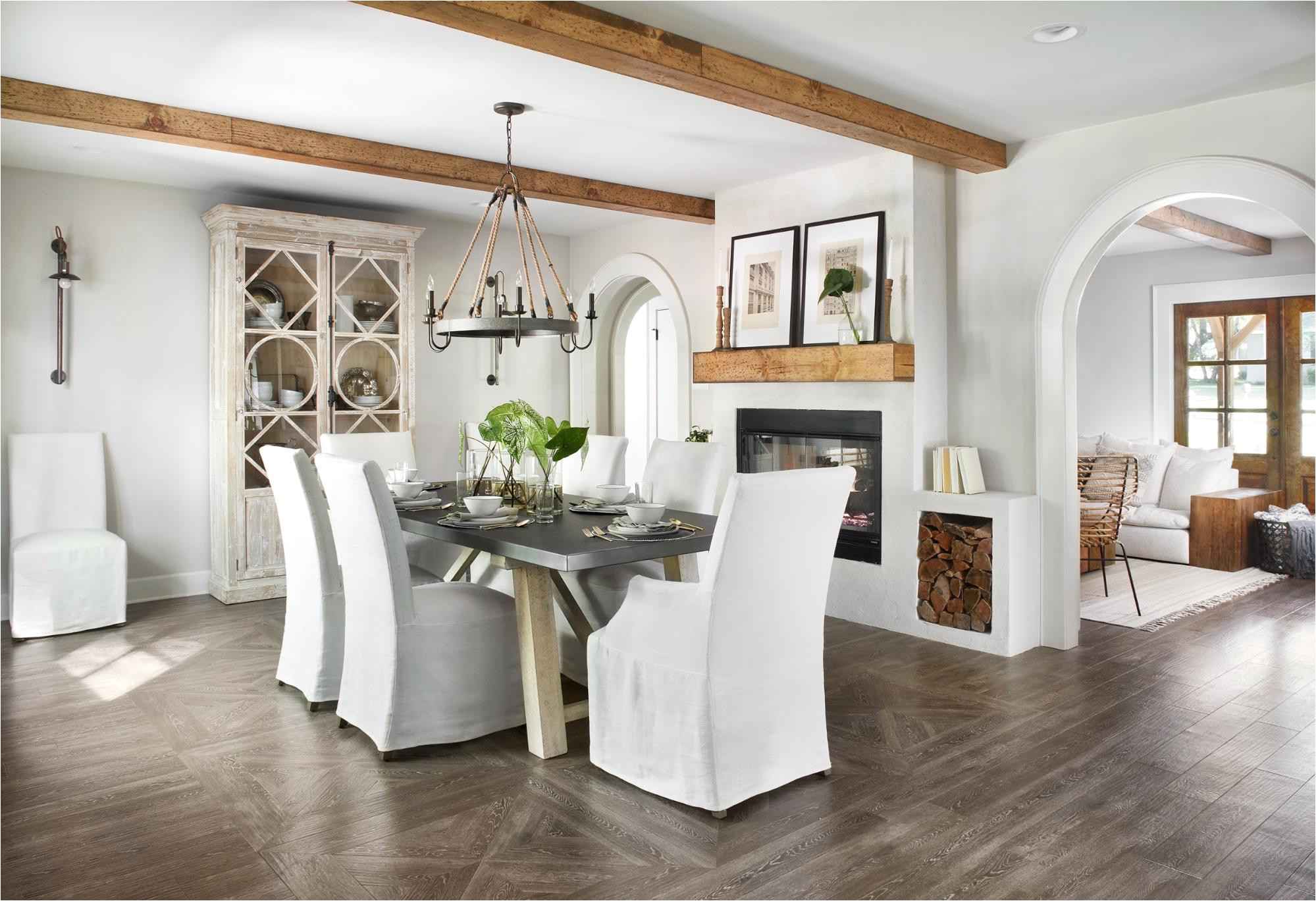 this room has the same wood beams as the living space as well as the same flooring the difference here is this parquet style pattern under the table