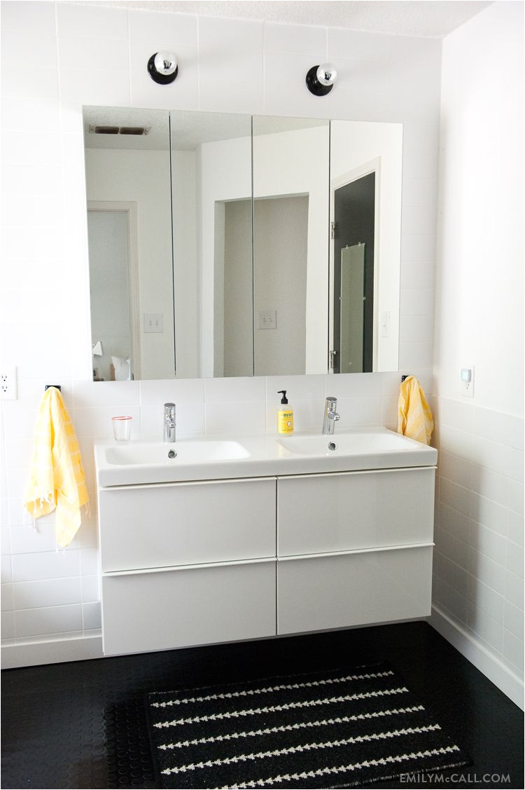 master bathroom with ikea godmorgon mirrored medicine cabinets and high gloss white sink cabinet odensvik sink nate berkus for target rug