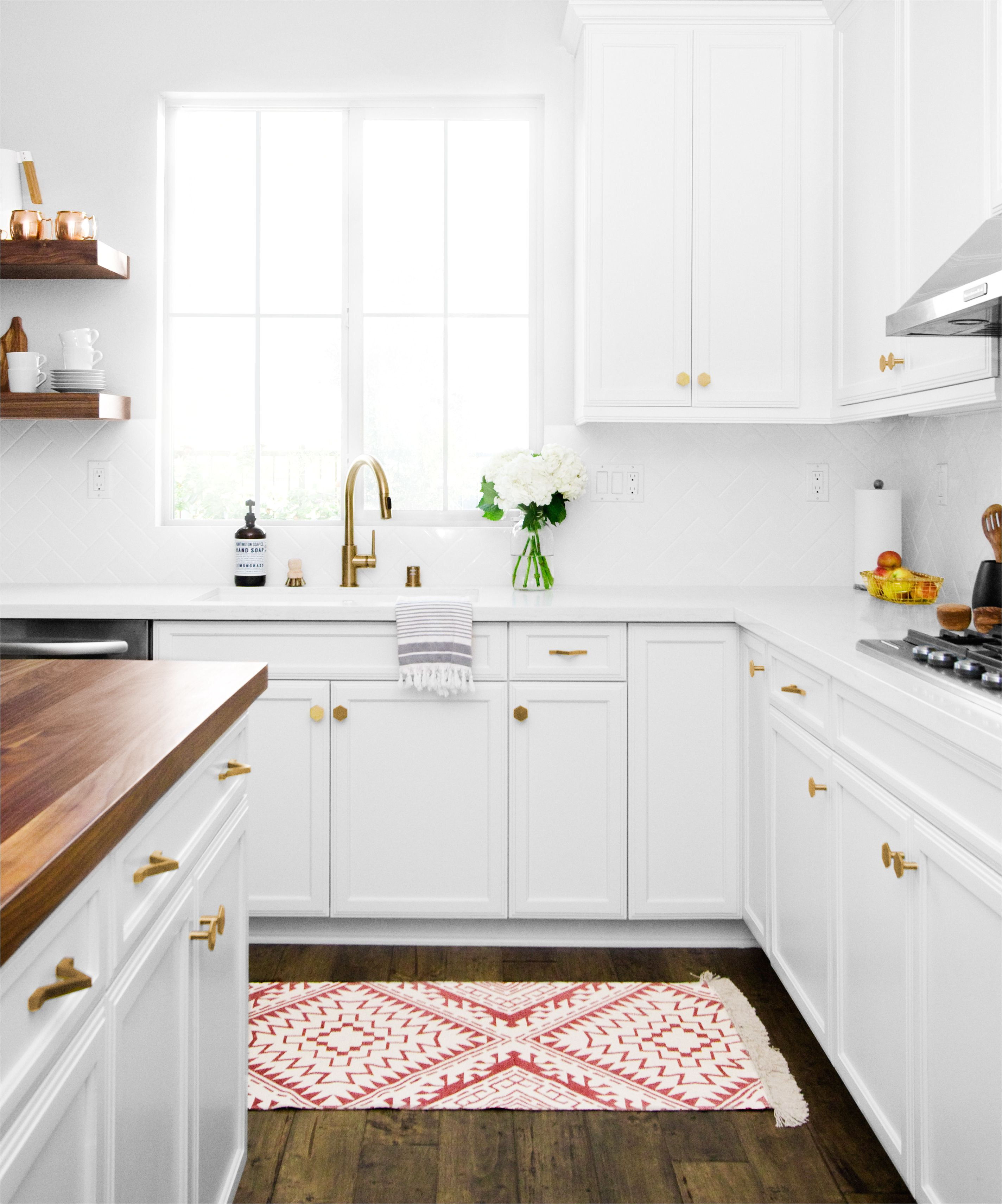 pugh project kitchen butcher block island floating shelves and gold accents