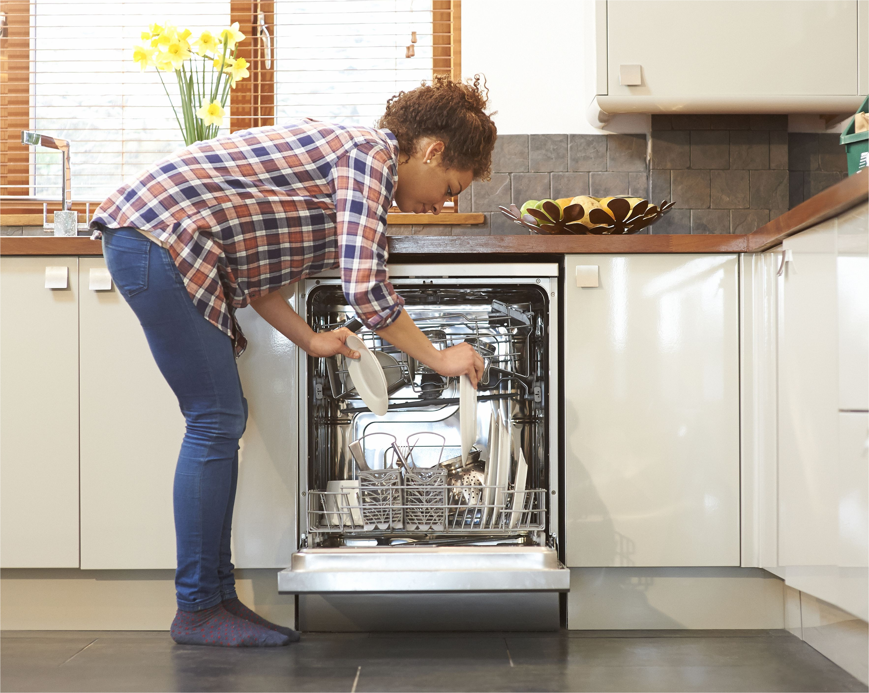 woman unloading dish washer in kitchen 483712233 57969bce3df78ceb8687e547 jpg