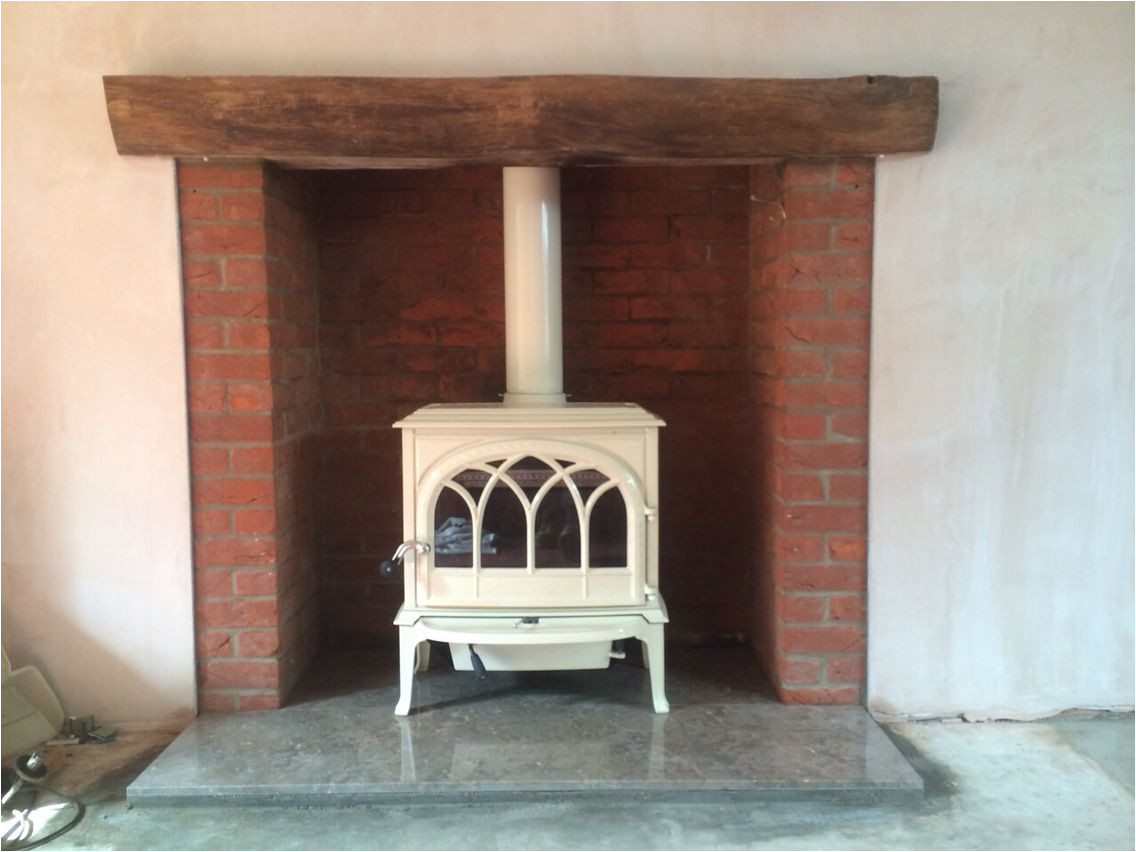 jotul f400 ivory enamel wood stove on coffee coloured hearth