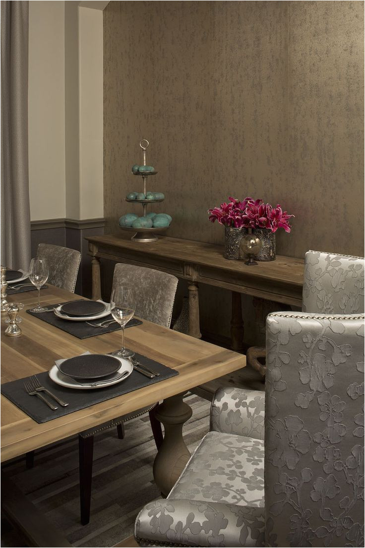 the combination of wood fabric and metals add textural interest to the space both soft and hard materials are used from the soft tone on tone floral