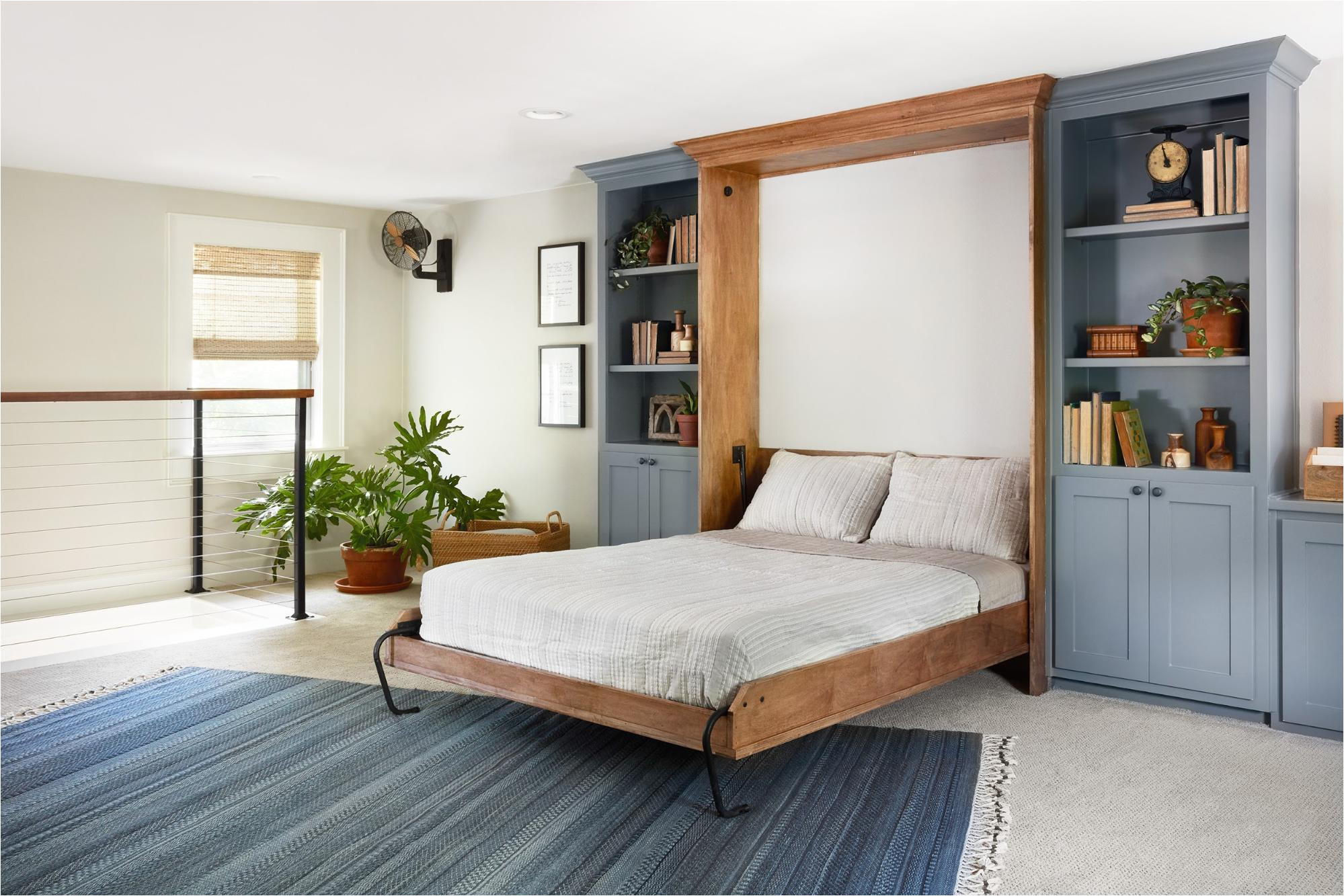 our solution for converting this space to a guest room was to incorporate a murphy bed since this room is in an upstairs loft style area of the home