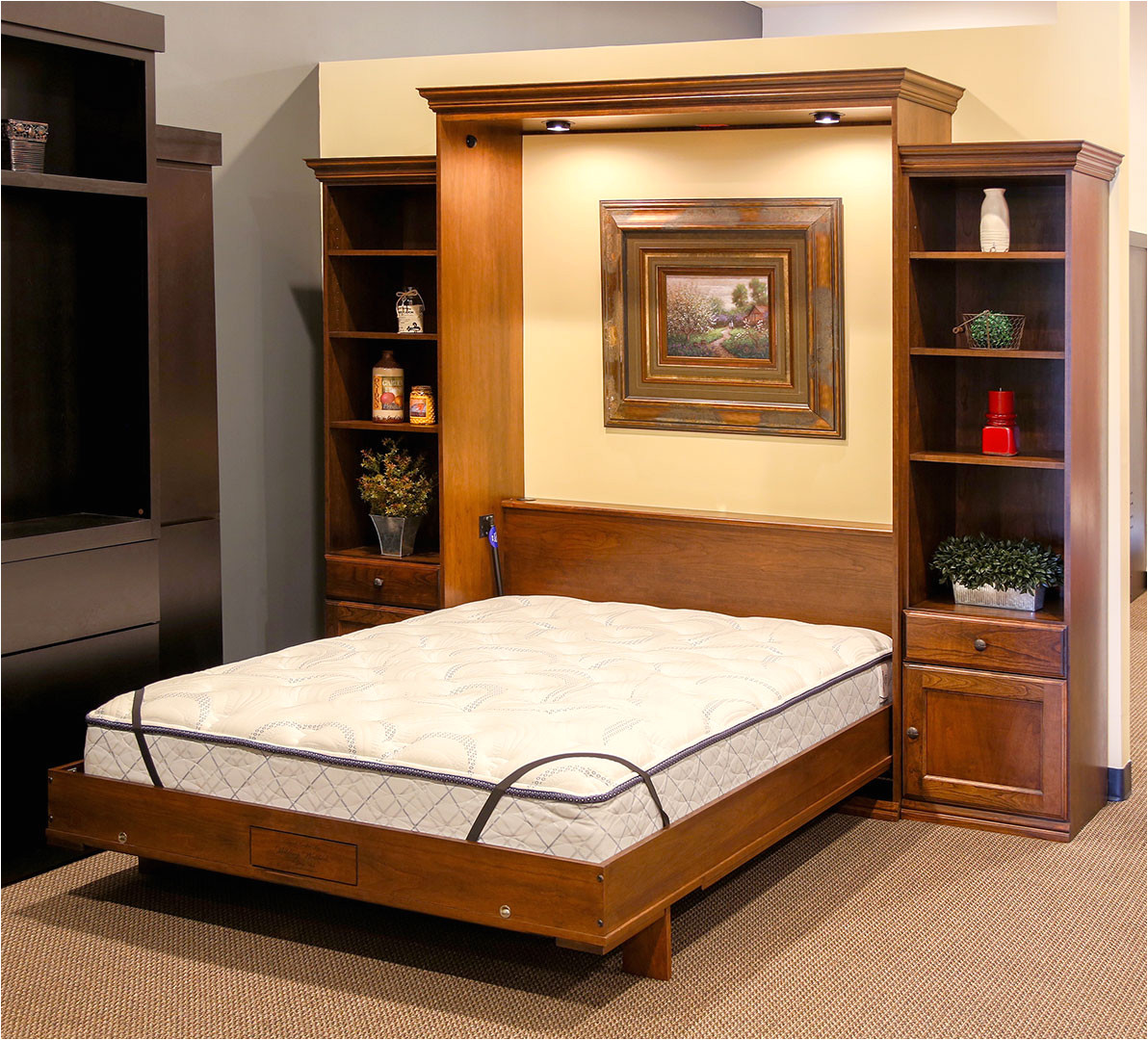 as you enter the back section of the store you ll find our extremely popular disappearing desk bed this disappearing desk is displayed in alder wood and