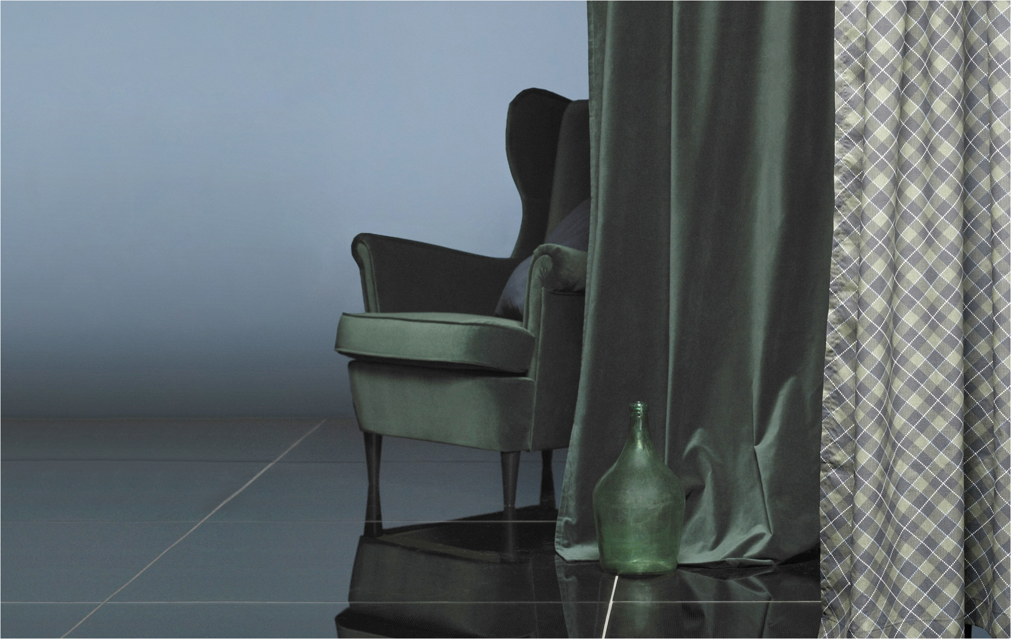 an armchair behind a curtain in matching dark green velvet