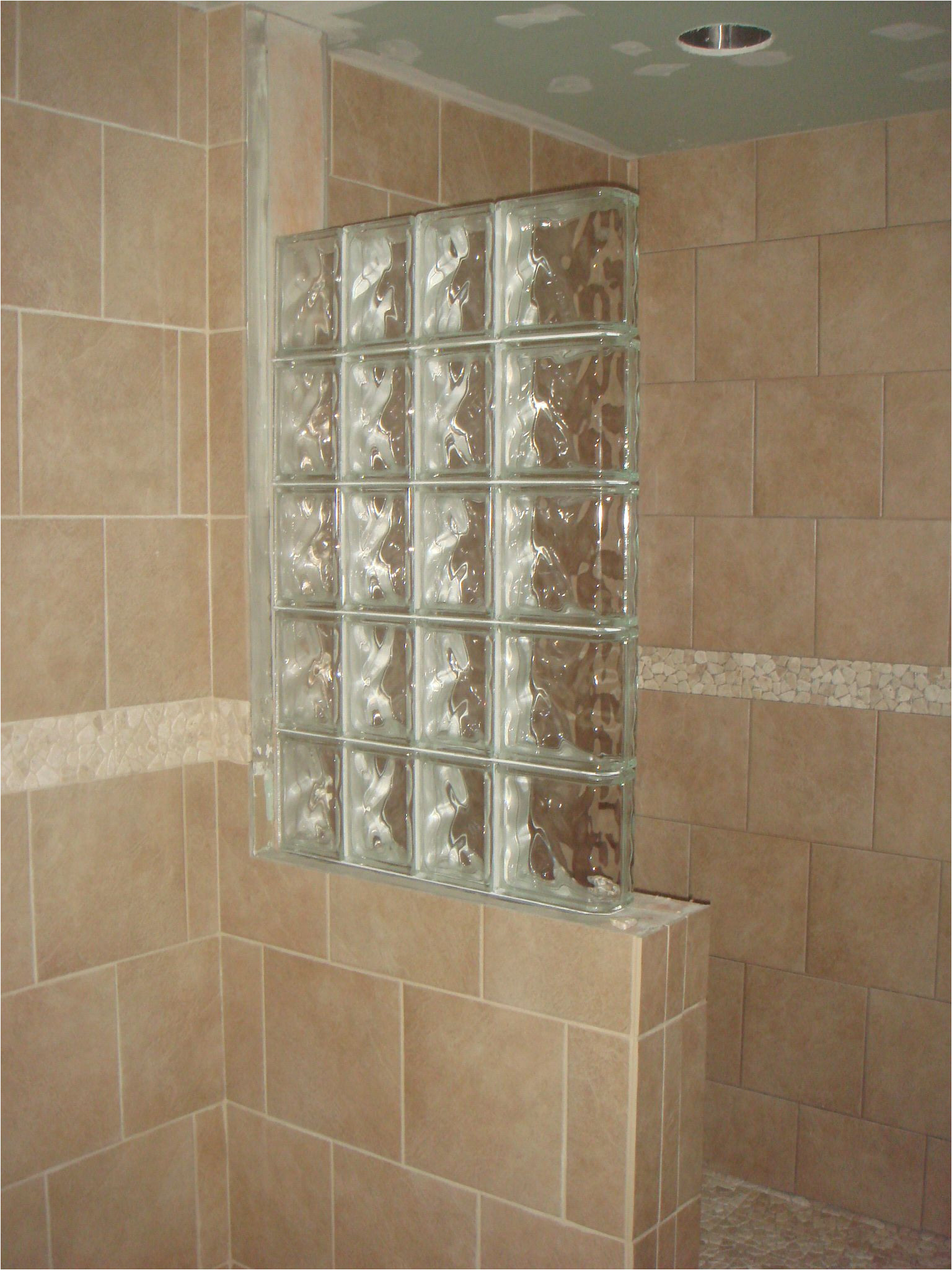 half wall shower design an addition some glass block wall and much of the grouting is done
