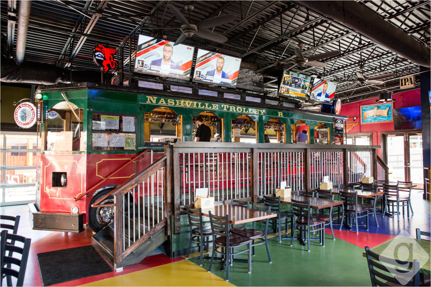 guests can sip on the elevated trolley area or at one of the many tables on the ground level