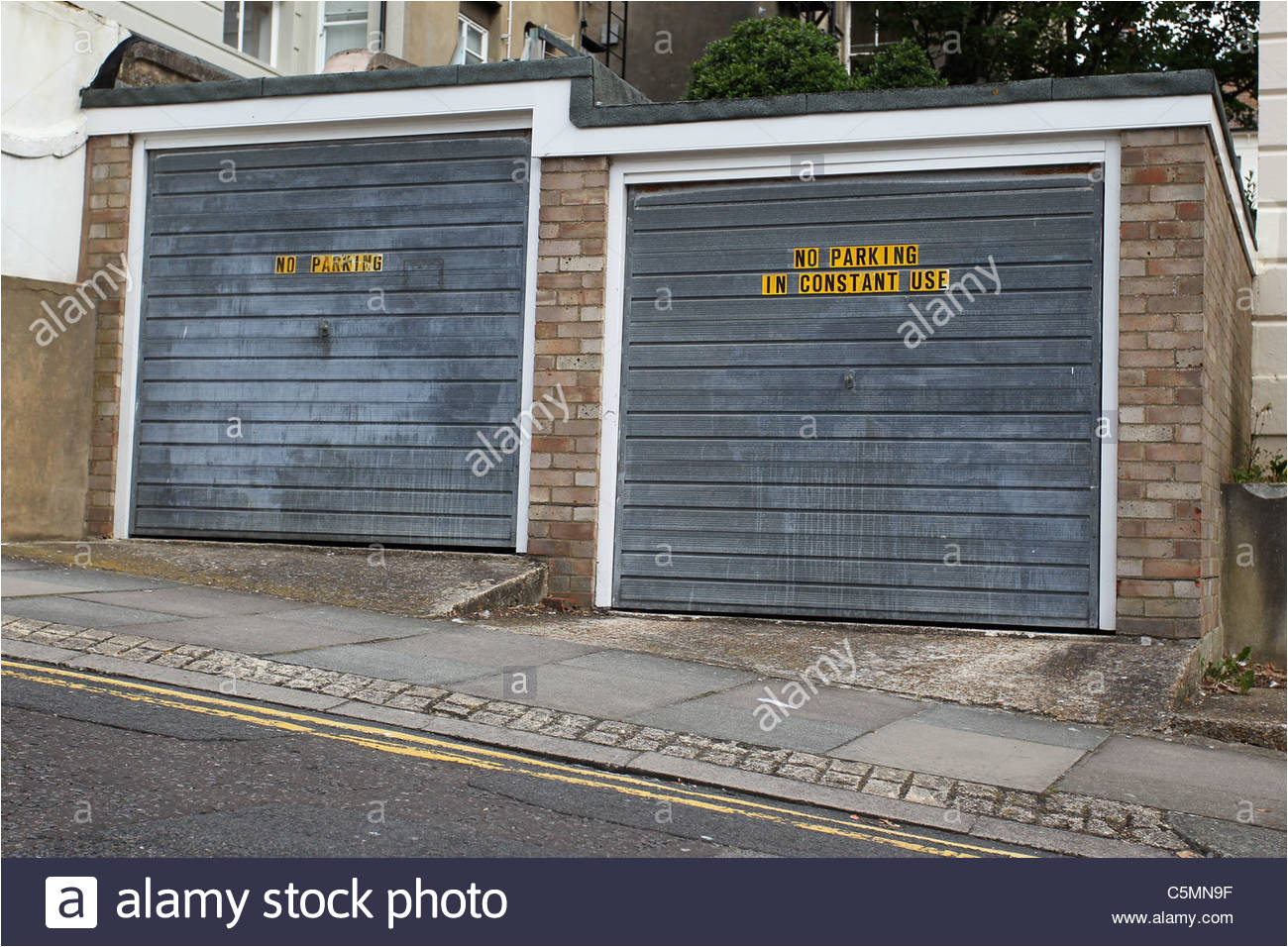 no parking garages in constant use signs on a couple of garages in brighton east