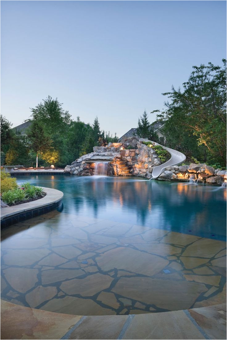 the natural boulder waterfall of this lagoon style pool definitely attracts attention the pool