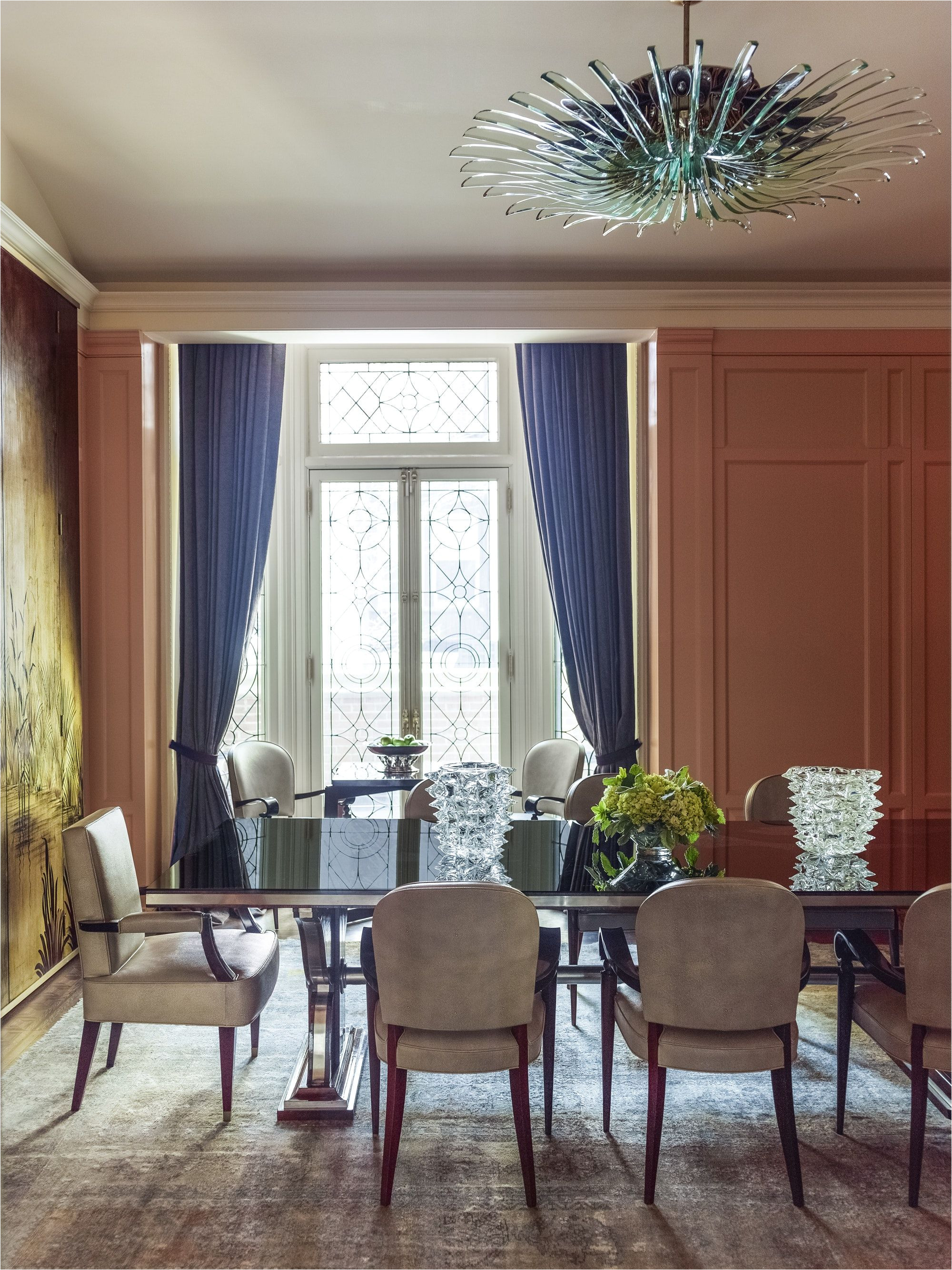 one focal point in this formal dining room is a green glass chandelier by max ingrand