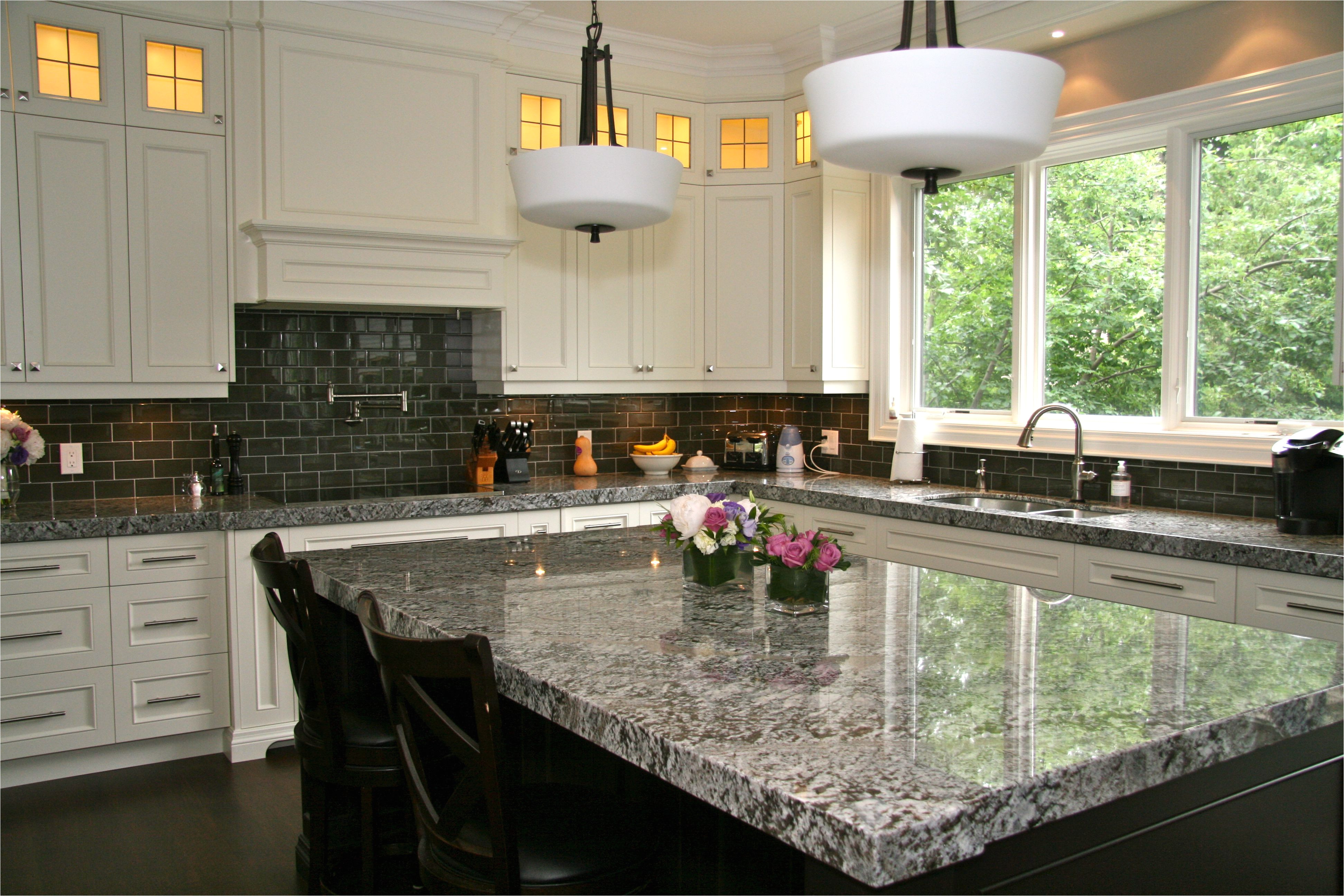 lennon granite completed with gray subway tiles and cupboard back lighting www marbleandmarble com lennon granite kitchen subway tiles