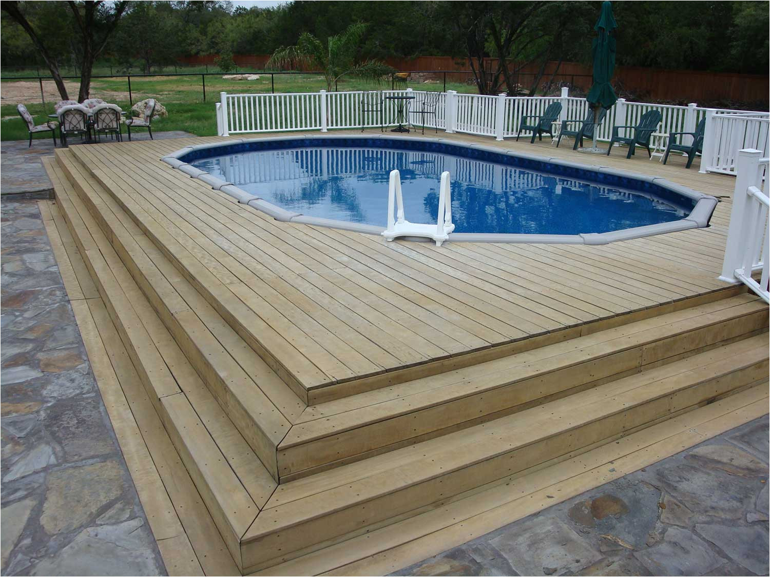 this simple pool has easily become part of the patio walkout with easy accessibility and welcoming cool waters