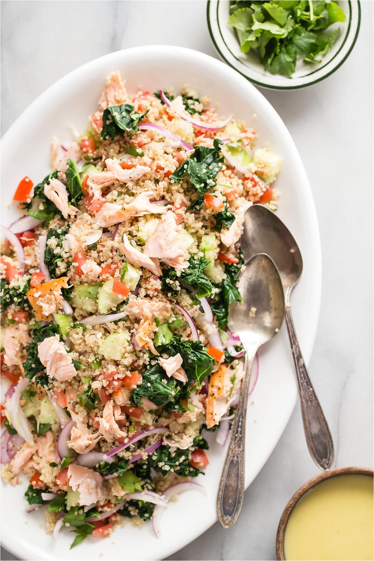 roasted salmon flakes with quinoa and fresh steamed kale this healthy kale salad is dressed in a tangy garlic and lemon sauce