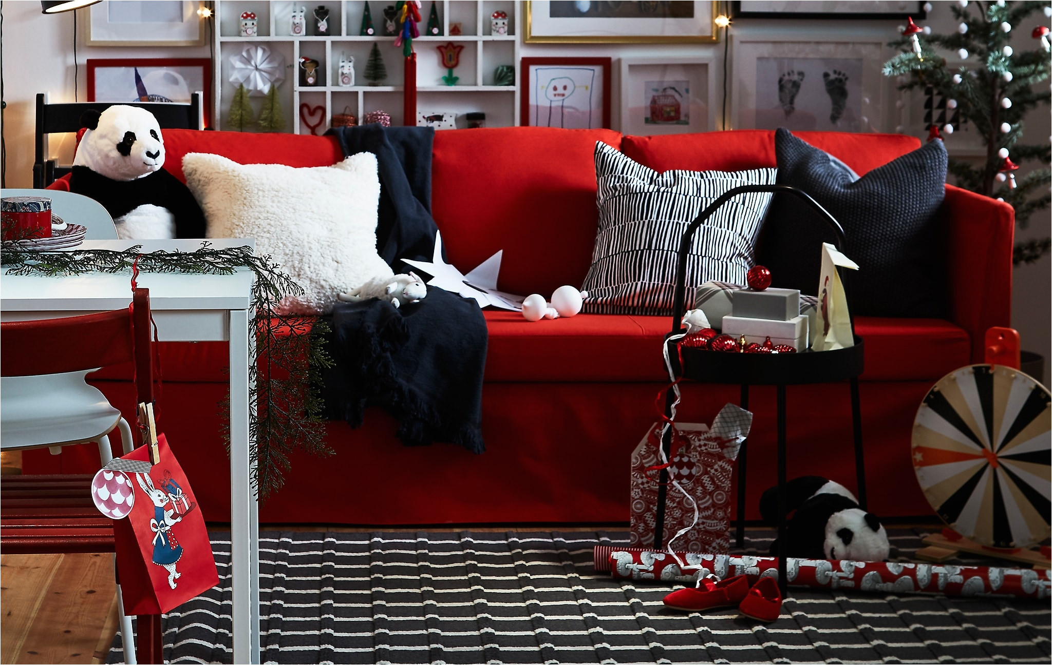 a red black and white living room with plenty of personal details and flexible furniture