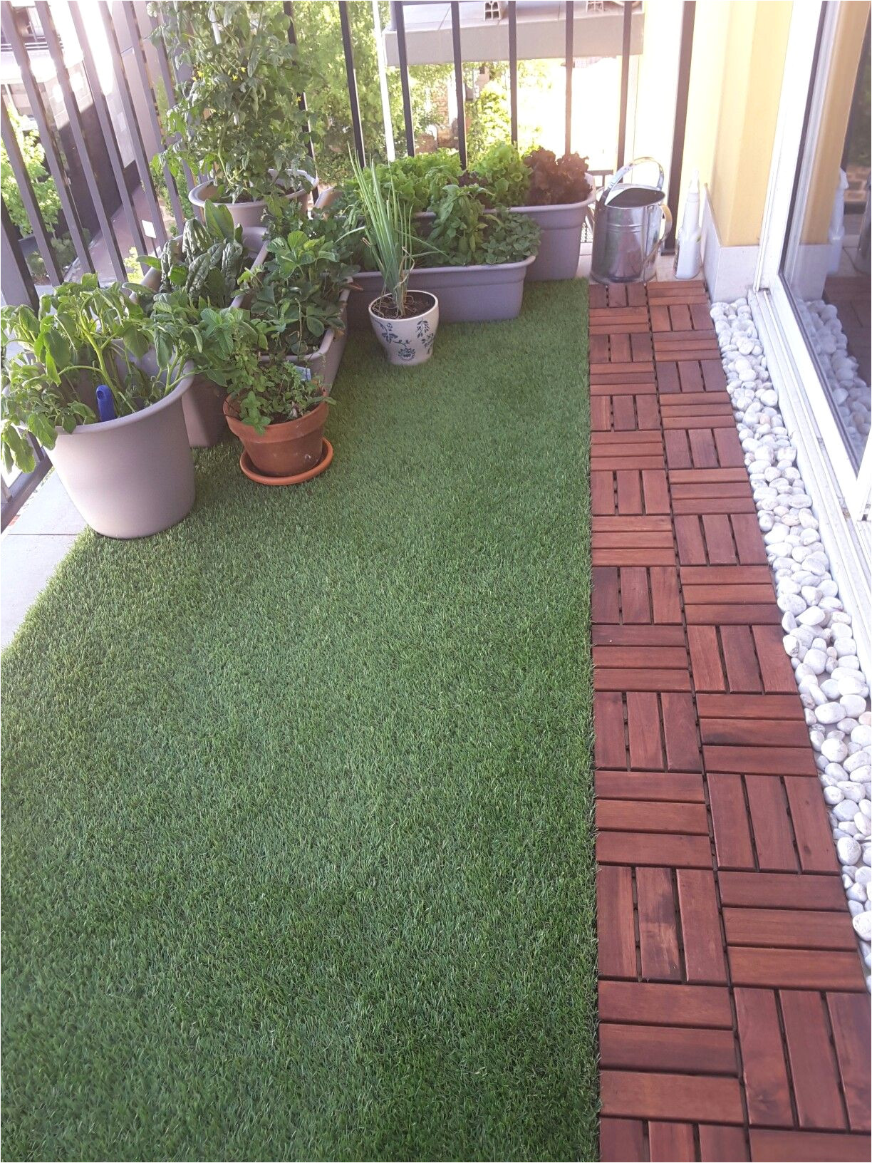 balcony with artificial grass decking and plants