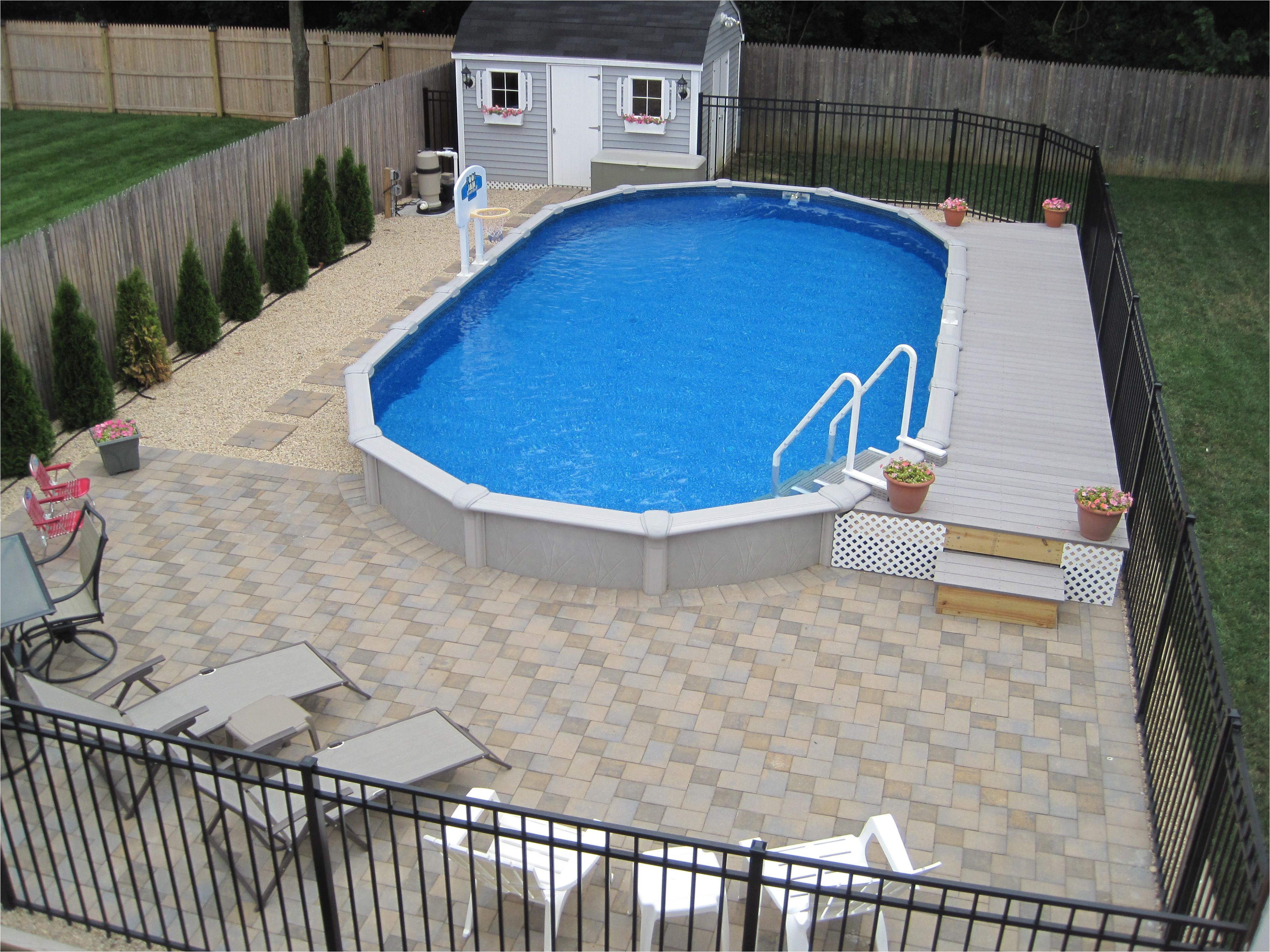 15x30 sharkline semi inground pool with deck and pavers