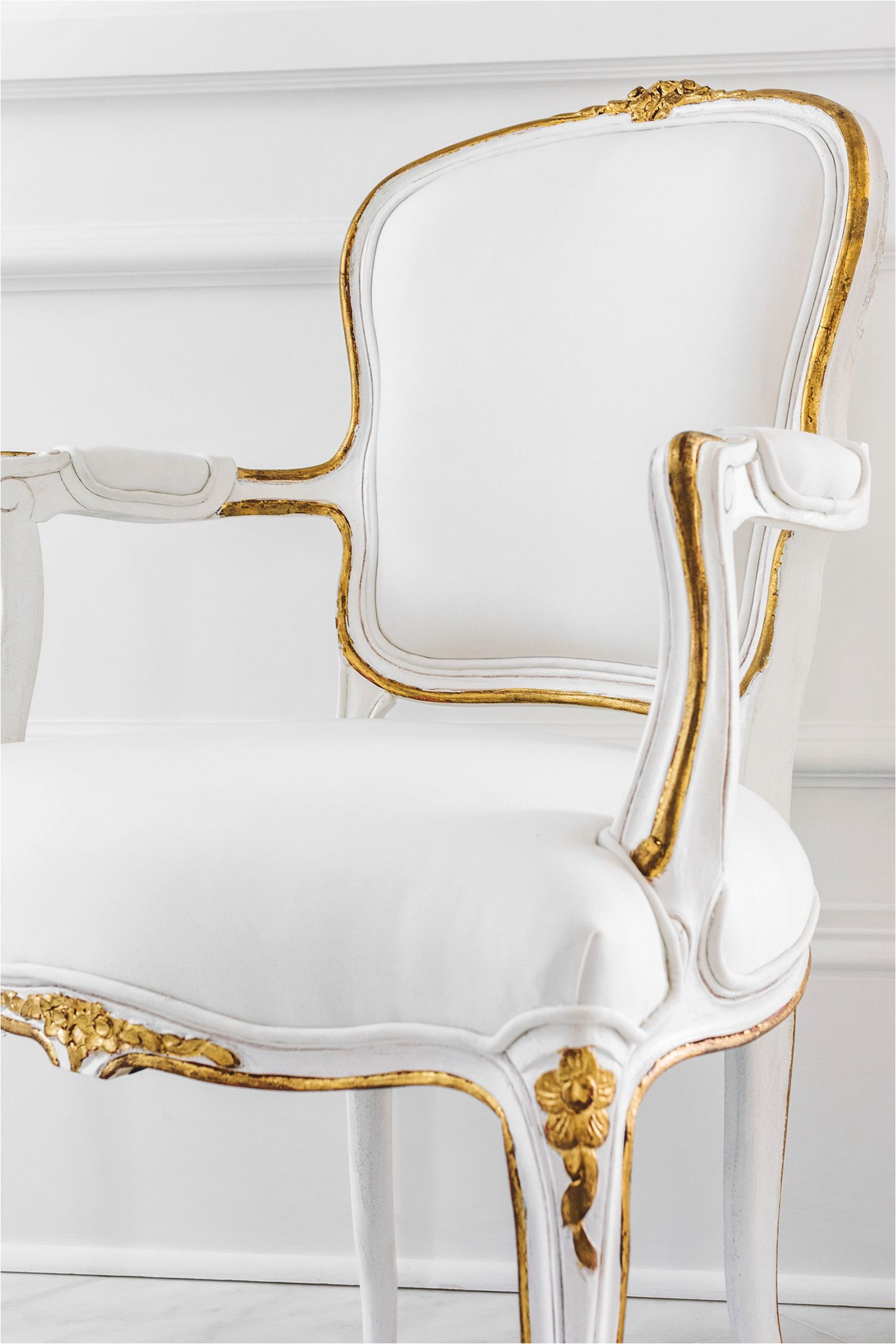 the hand crafted louis xv style regent side chair features delicate floral carvings a hand applied white finish gilded accents and white upholstery