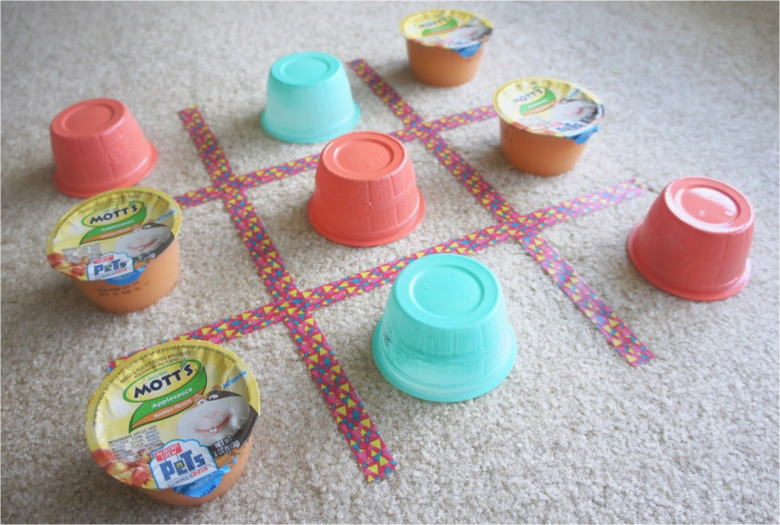 applesauce cups for a diy backyard tic tac toe game