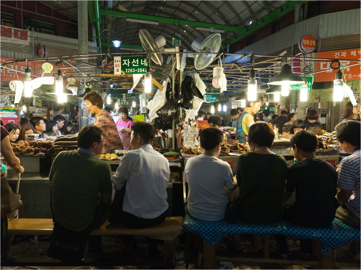 people eating at the food stalls at gwangjang street market photo by elena ermakova shutterstock