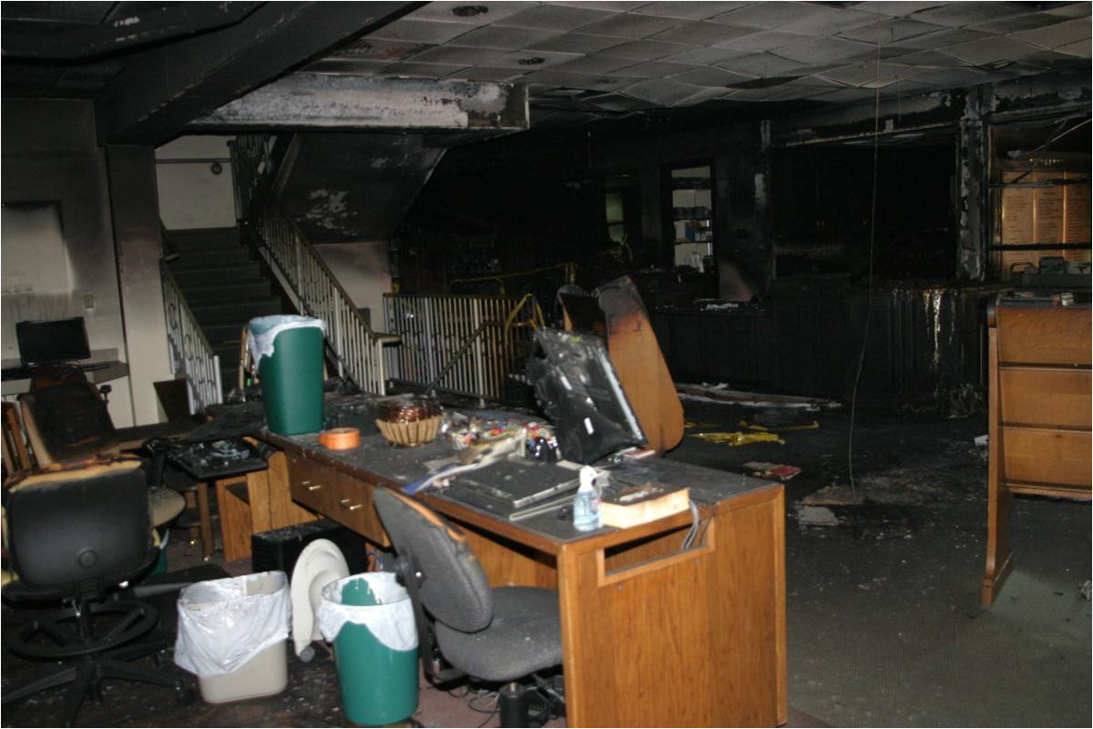 chuck knox who is leading the effort to restore eckhart public library after an arson fire inspects the spot where the fire started a firework placed in