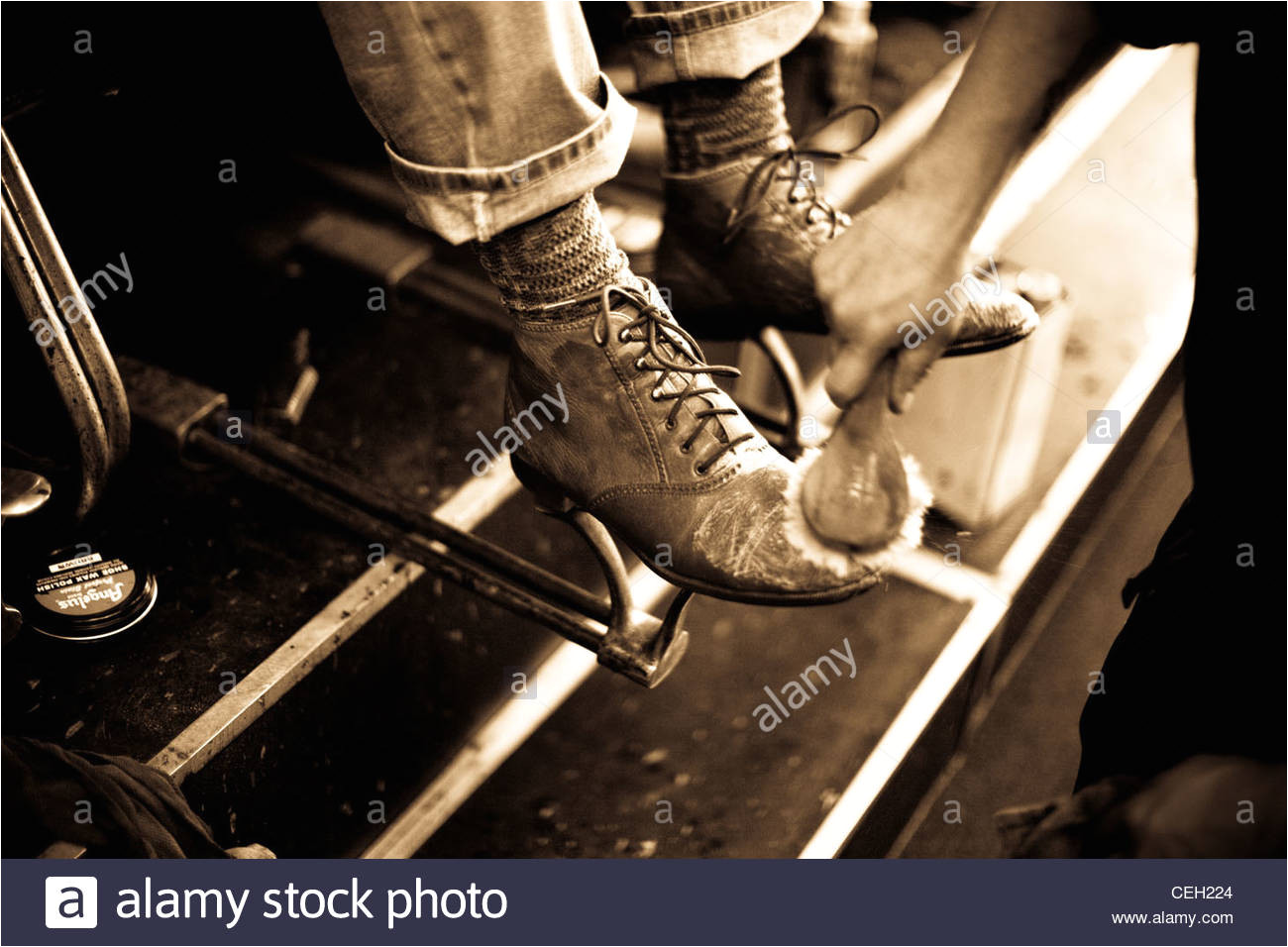 worn boots being polished at a shoe shine stand stock image