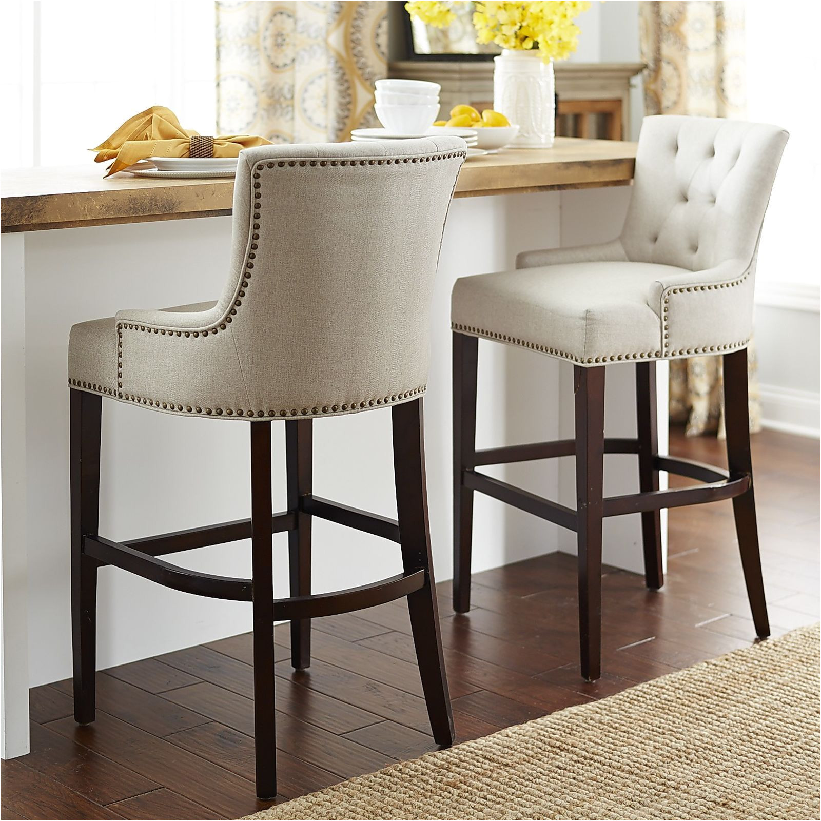 our ava stools offer a most elegant perch classic tailoring includes a comfortable contoured back with deep button tufting low slung swoop armrests