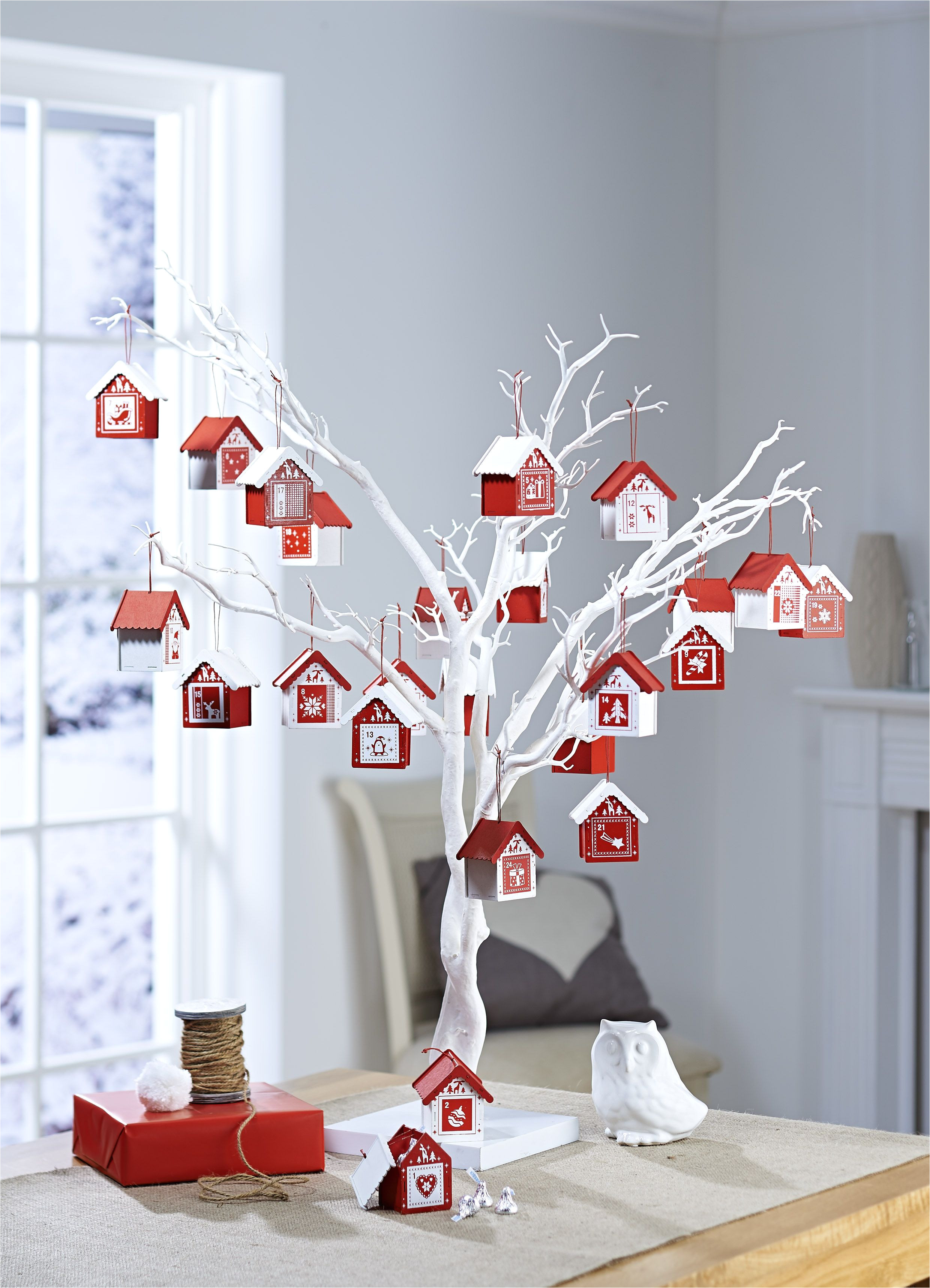 bored of the usual cardboard advent calendars with chocolate button inserts well how about this idea for a change advent houses on a white twig tree from