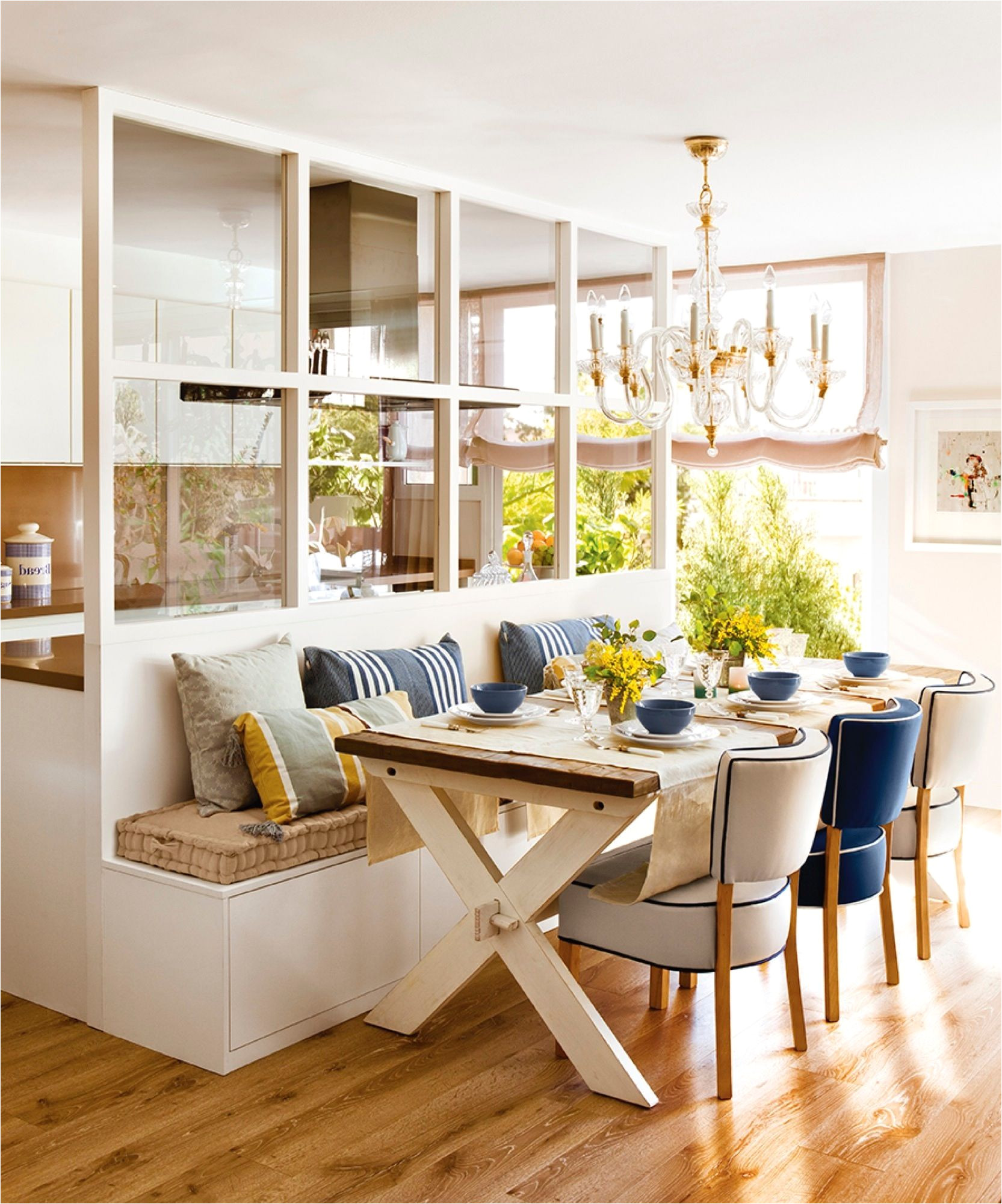 comedor conectado con la cocina con banco mesa de madera y lampara de araa a