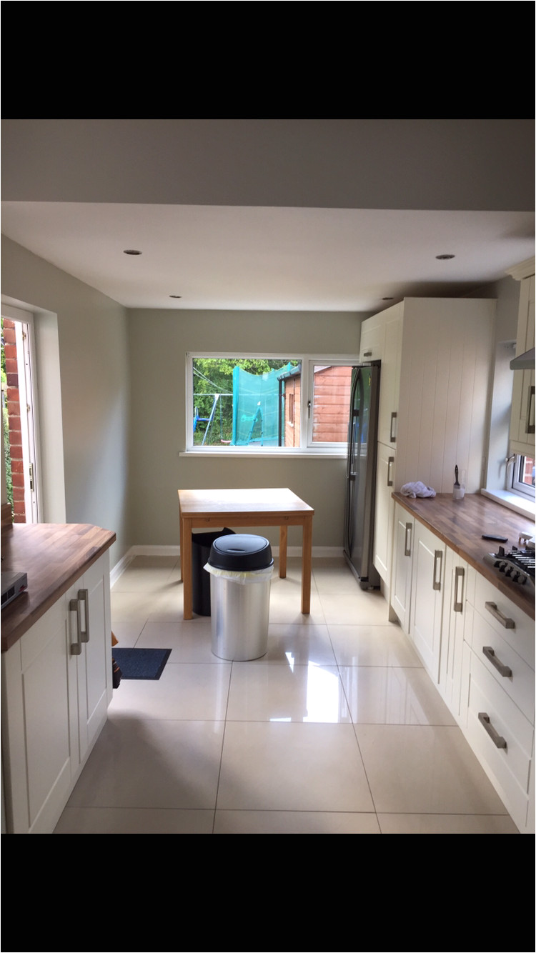kitchen wall colour in daylight farrow and ball cromarty with cream shaker units and cream high gloss porcelain tiles