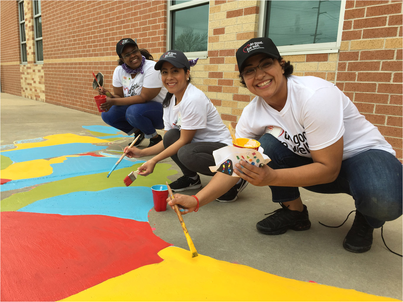 volunteers paint a map of the us on asphalt at south houston elementary playground