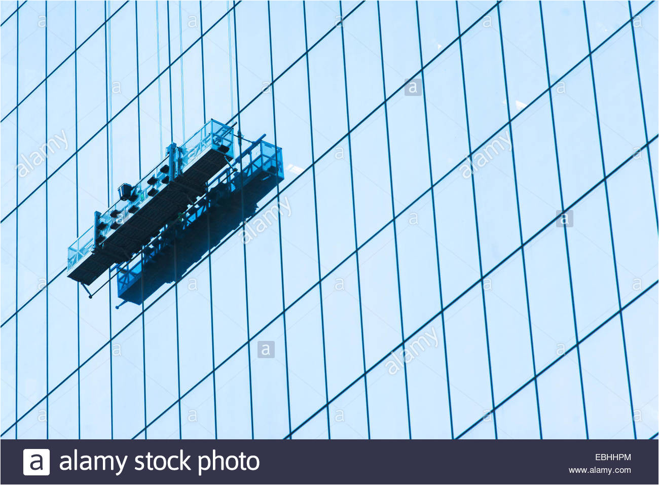 suspended window cleaning platform on glass building stock image