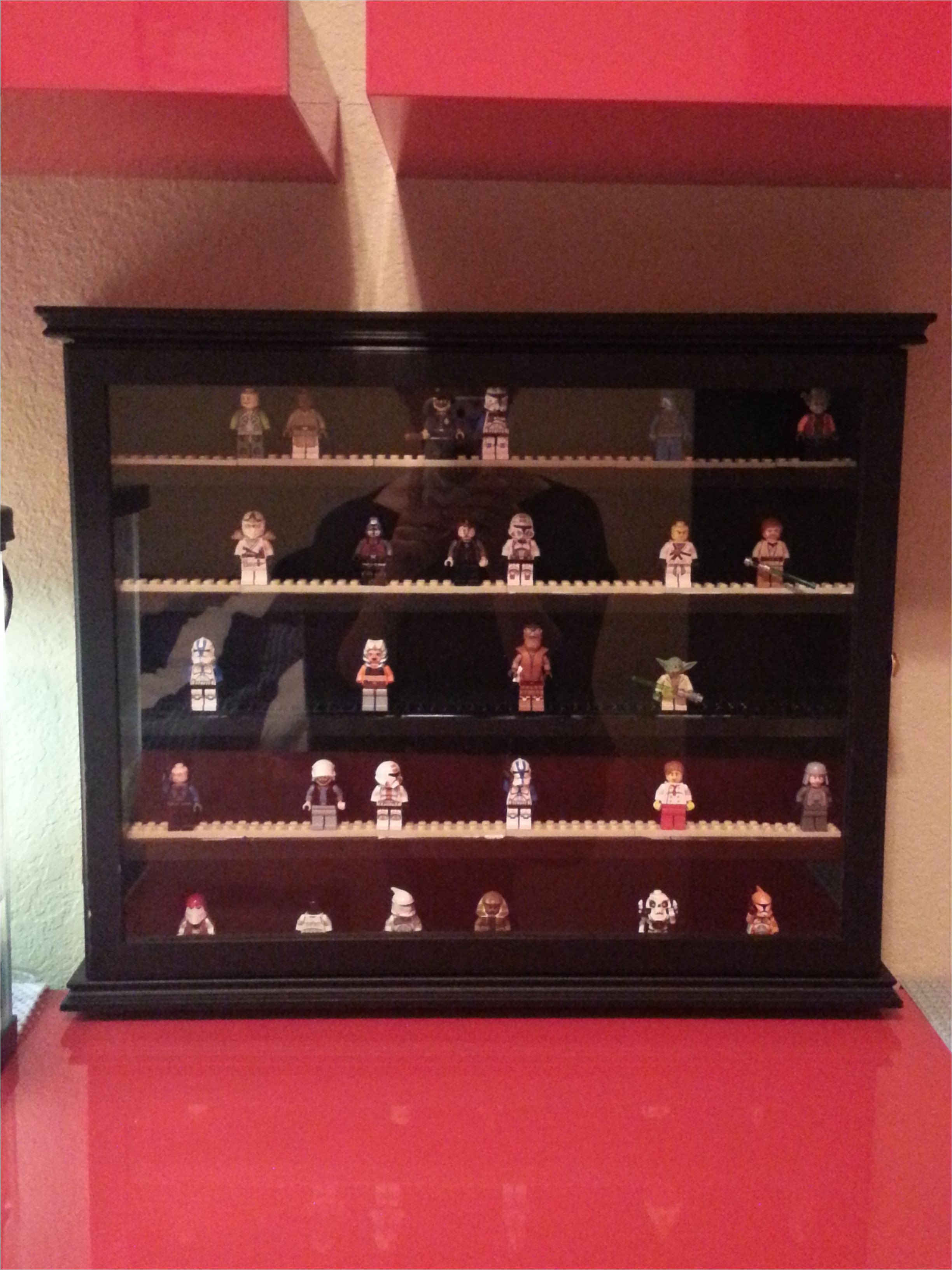 lego minifigure display case made from a golf ball display case i found on clearance at kohl s for 9 99 i glued flat lego pieces to the shelves and voila