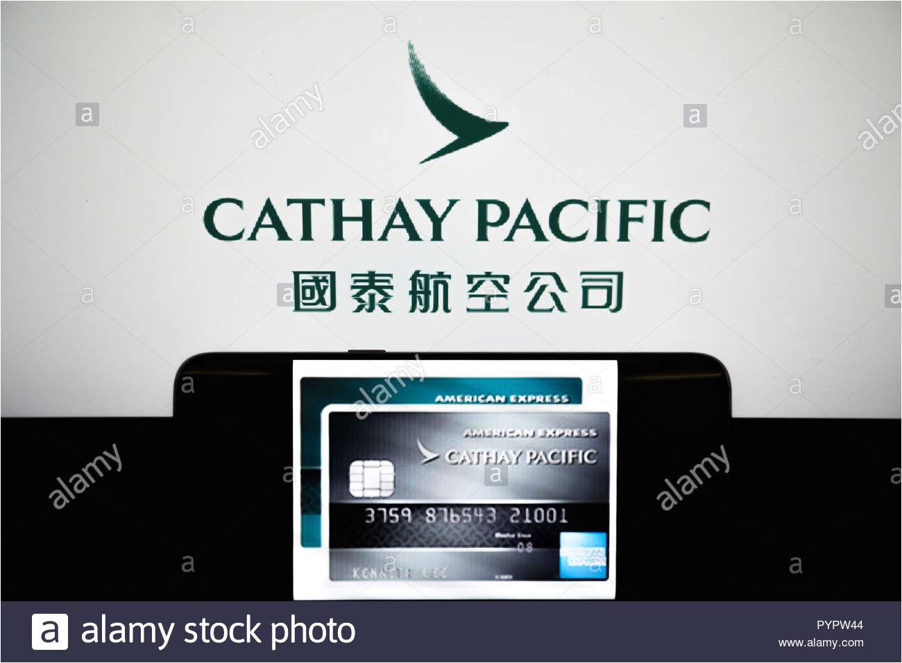 cathay pacific credit card displayed on a smartphone in front of a background of the cathay