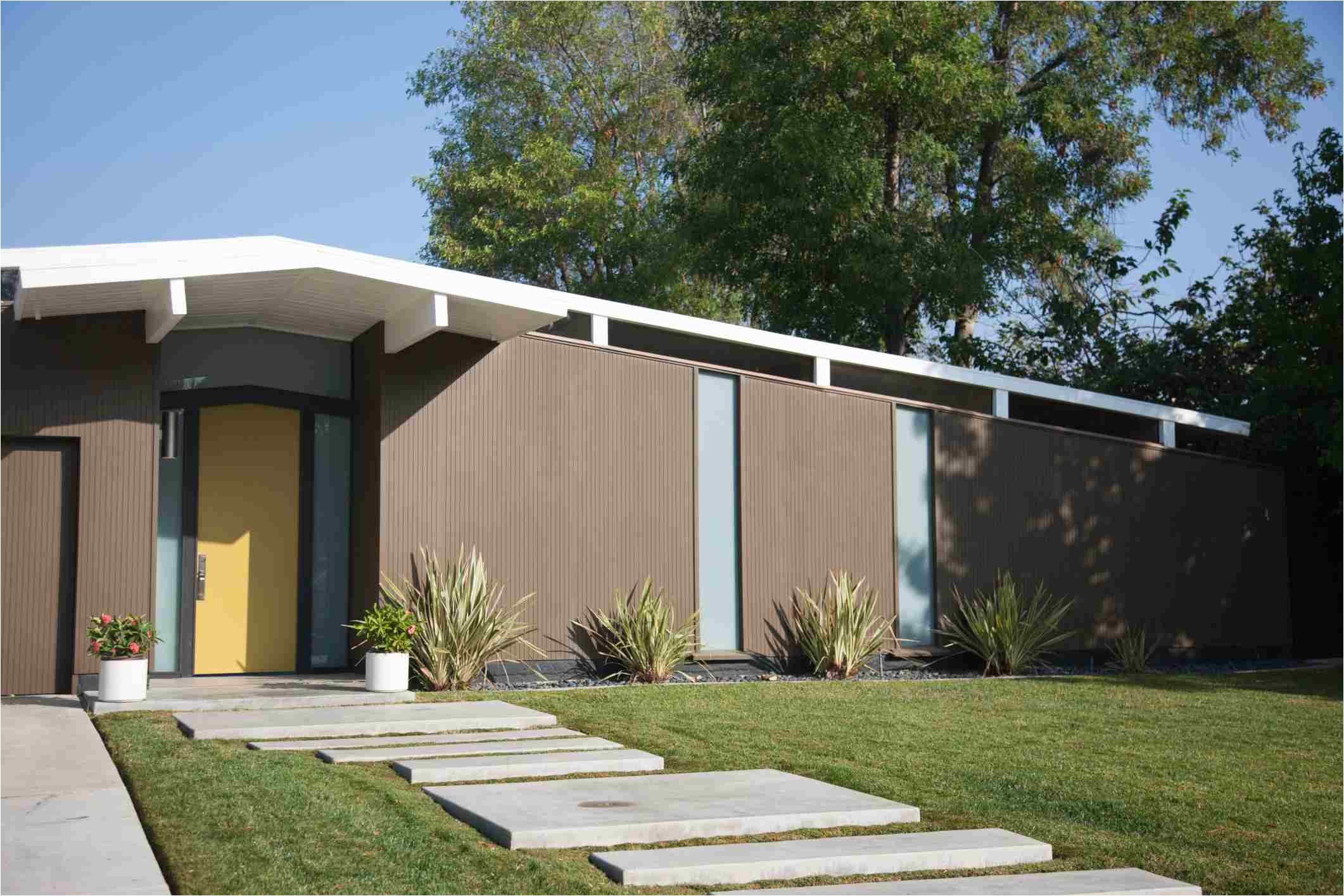 mid century modern house with concrete walkway 168532965