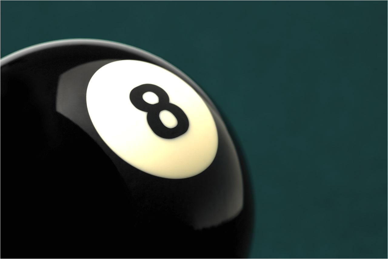 black ball with the number 8 on it shot on green pool table studio