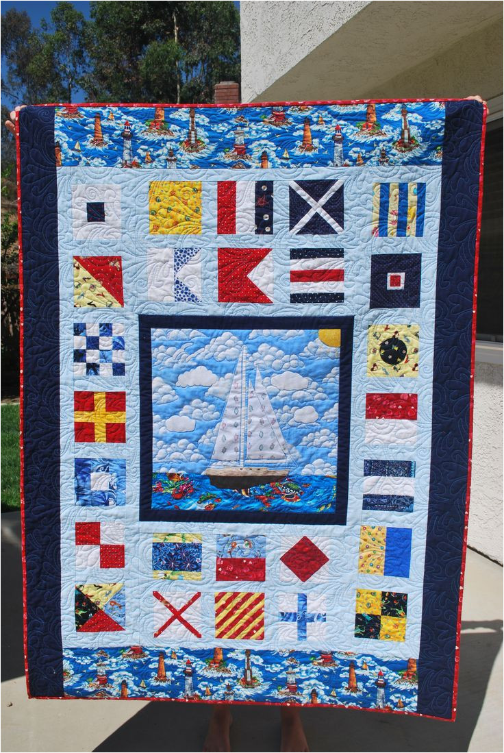 custom nautical quilt for my sister all a z nautical flags and her boat appliqued in the center made with scraps fabrics in the red blue yellow